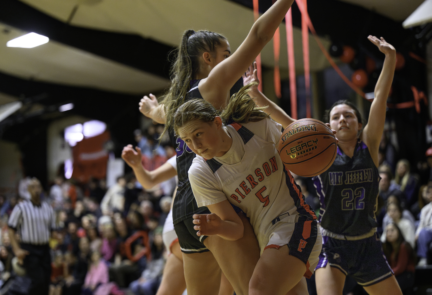 Pierson freshman Josie Mott tries to drive along the baseline out of a double team.  MARIANNE BARNETT