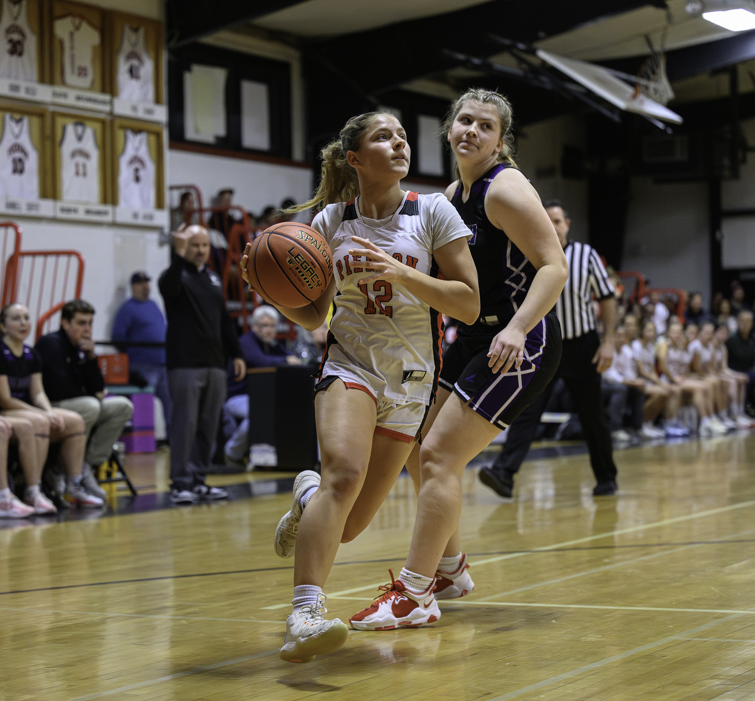 Pierson's Lola Eldridge drives passed by a Port Jeff defender.  MARIANNE BARNETT