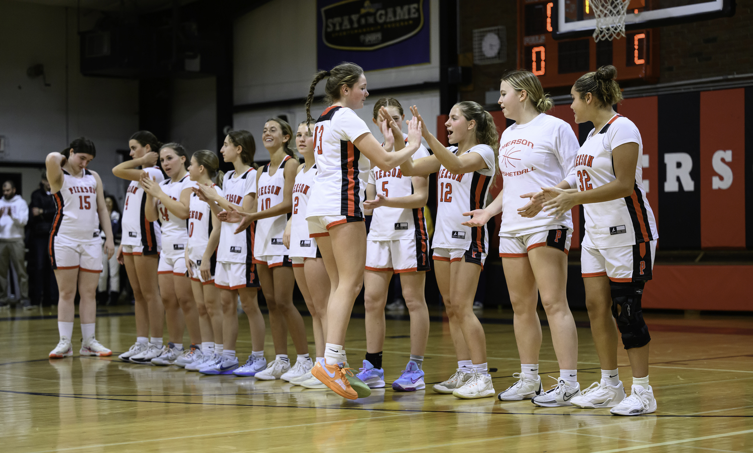 Cali Wilson joins her team during player introductions prior to Friday night's game.   MARIANNE BARNETT