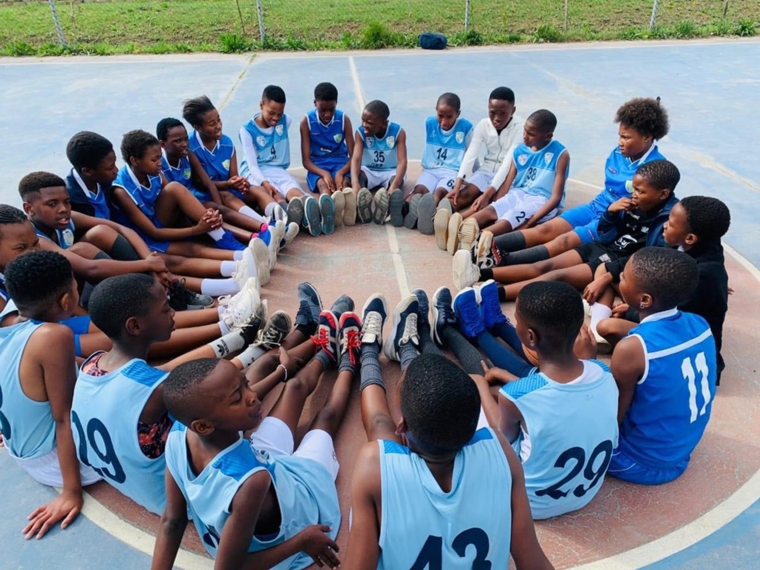 Players at a Hoops 4 Hope camp in South Africa sit in a circle. Many of them communicated back and forth with students at the Montauk School. COURTESY ANTHONY ALLISON