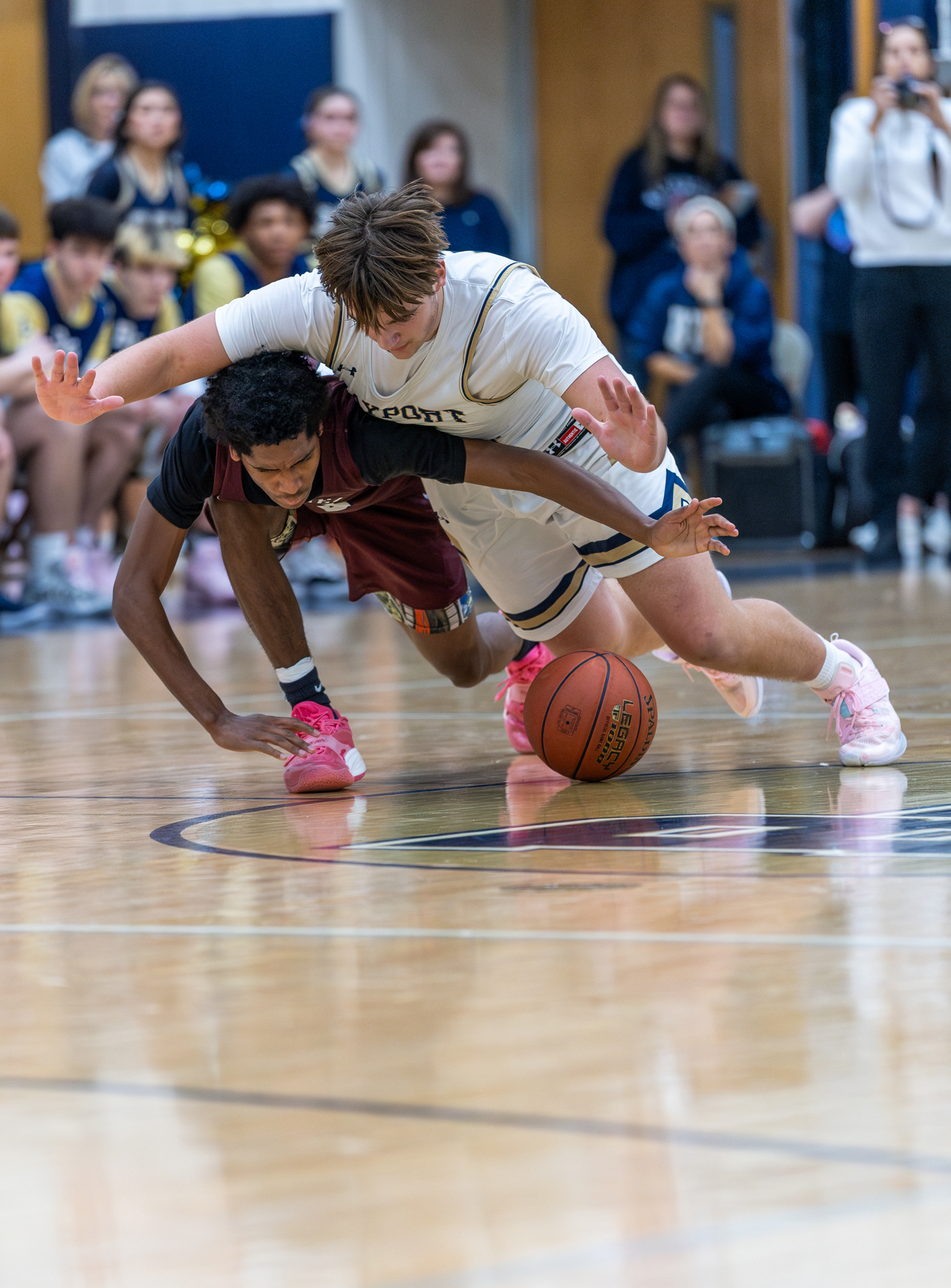 Southampton senior Tyrese Reddick and Bayport-Blue Point senior Evan Waldbauer both go for a loose ball at midcourt.   RON ESPOSITO