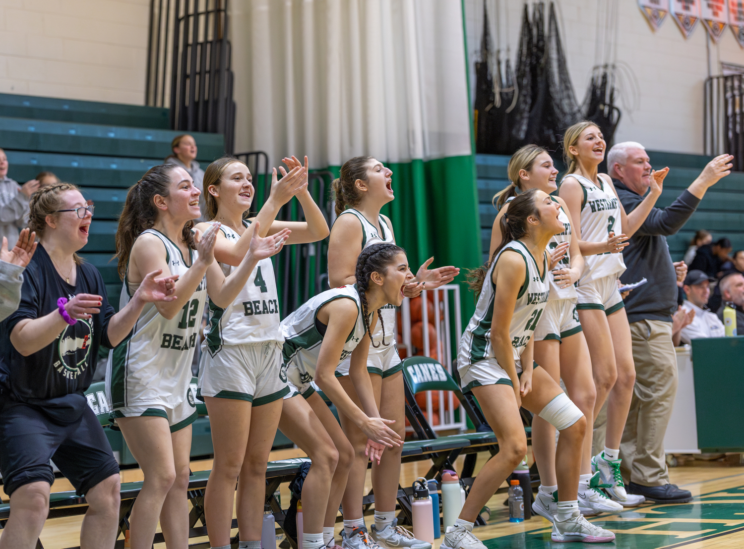 Westhampton Beach's bench erupts in celebration of Shannon Sweet's three-pointer. RON ESPOSITO