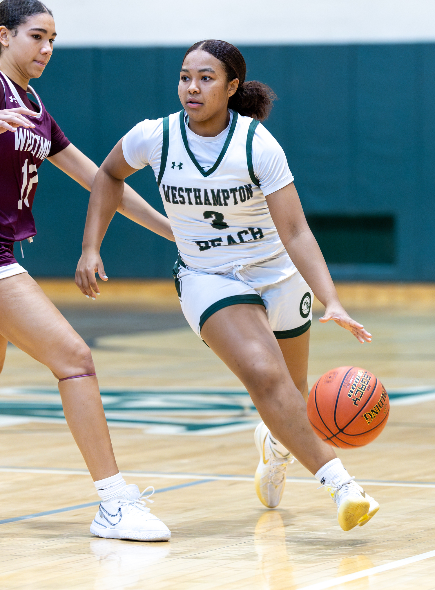 Junior point guard Sandra Clarke carries the ball into Walt Whitman's zone. RON ESPOSITO