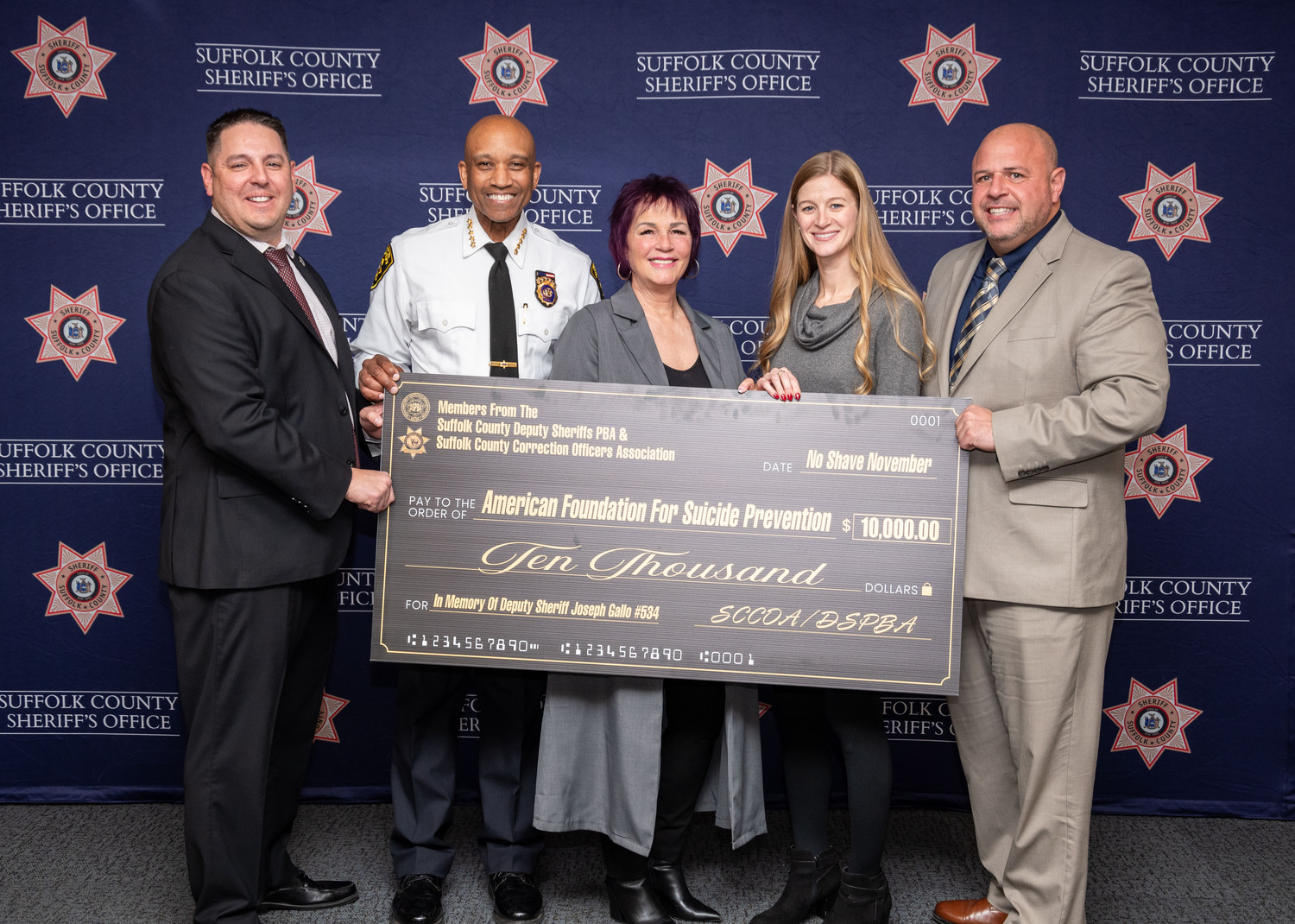 Suffolk County Sheriff Errol D. Toulon Jr. recently joined with the Deputy Sheriff’s Police Benevolent Association and the Suffolk County Correction Officers Association  to present a check to the American Foundation for Suicide Prevention respresenting money raised during the Sheriff’s Office’s annual No Shave November fundraiser. 
During the month of November, Correction Officers and Deputy Sheriffs were allowed to skip shaving in return for making a donation to the AFSP.  This year, the fundraiser was dedicated in memory of Deputy Sheriff Joseph Gallo who died earlier this year and had led the Suffolk County Sheriff’s Office in participating in No-Shave November in years past. The fundraiser netted $10,000. From left, DSPBA President Thomas Bivona, Suffolk County Sheriff Errol D. Toulon Jr., AFSP Executive Director Long Island Chapter Ann Morrison-Pacella, AFSP Long Island Program Manager Katie Deitz, and SCCOA President Louis Viscusi. COURTESY SUFFOLK COUNTY SHERIFF'S OFFICE