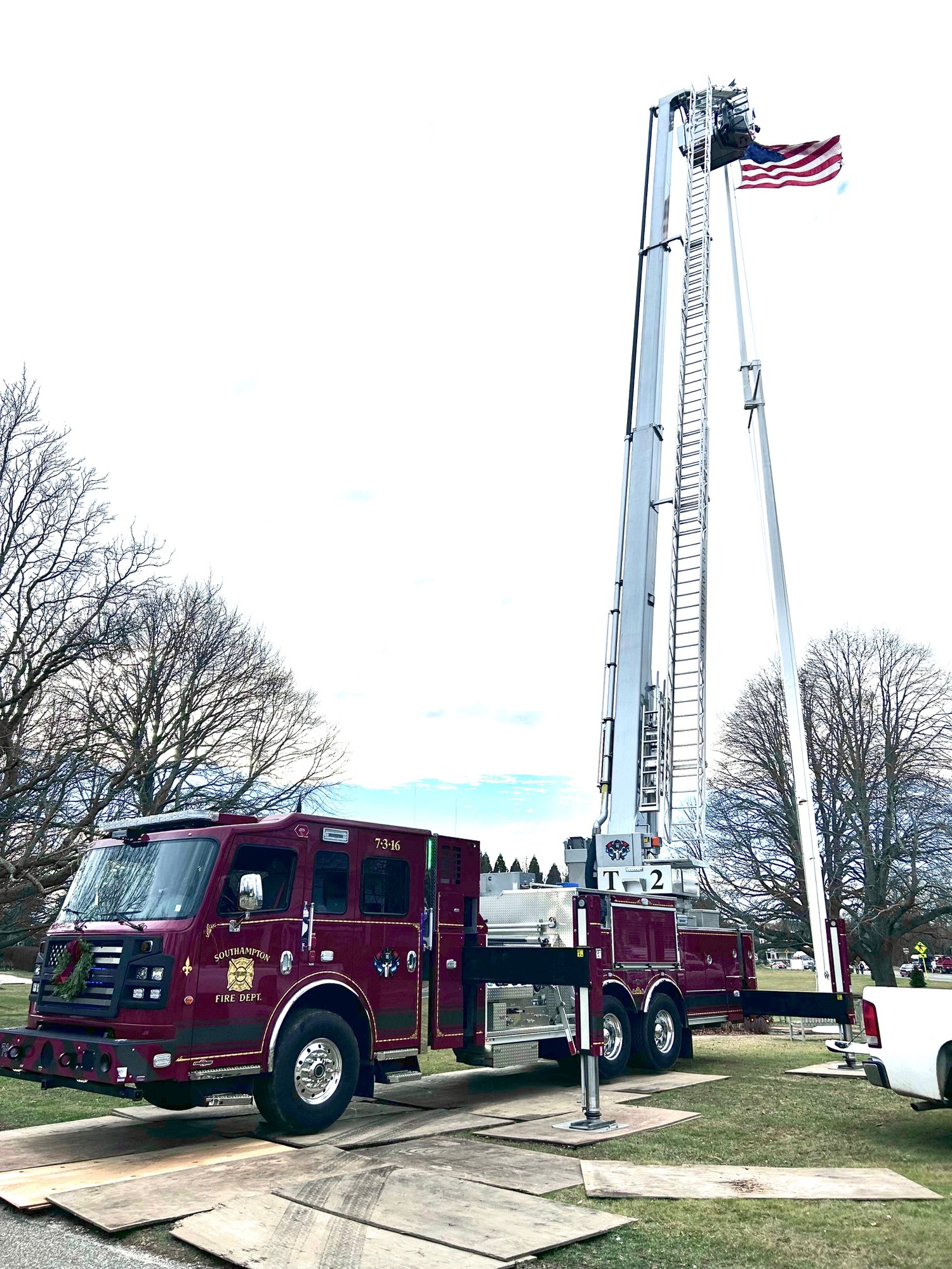 The Southampton Fire Department and David Raynor Landscaping recently lent a hand to the Water Mill Village Improvement Association when the flag on the Water Mill Village Green became stuck at the top of the 100’ flagpole. COURTESY WMVIA