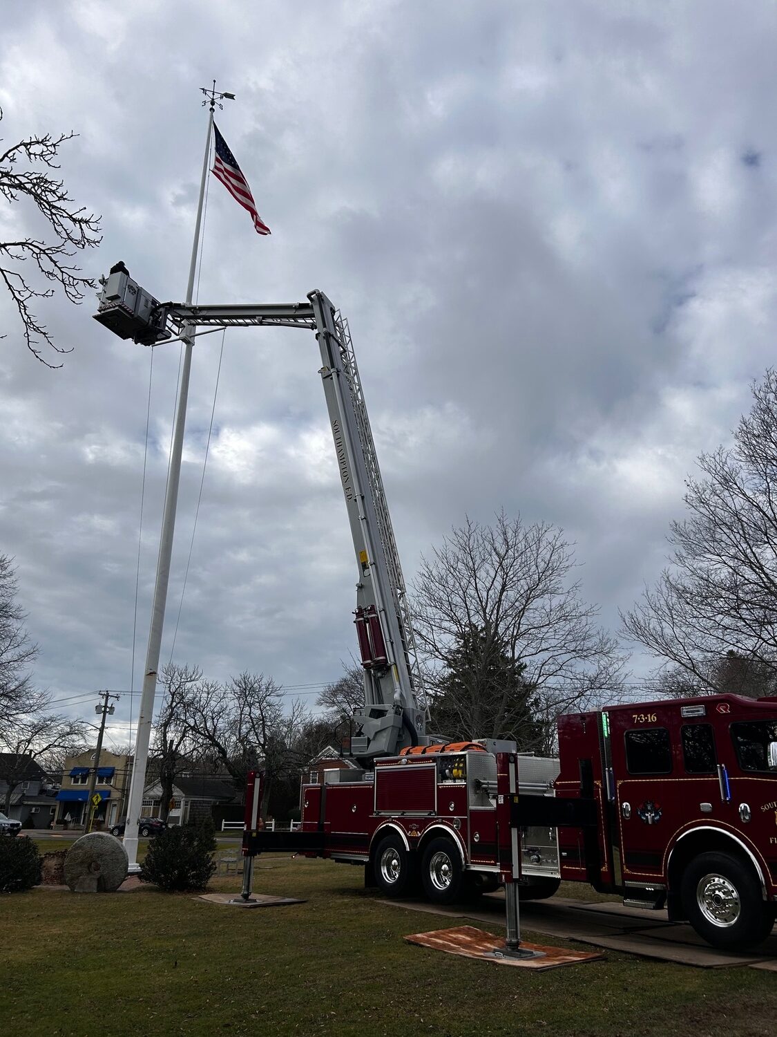 The Southampton Fire Department and David Raynor Landscaping recently lent a hand to the Water Mill Village Improvement Association when the flag on the Water Mill Village Green became stuck at the top of the 100’ flagpole. COURTESY WMVIA