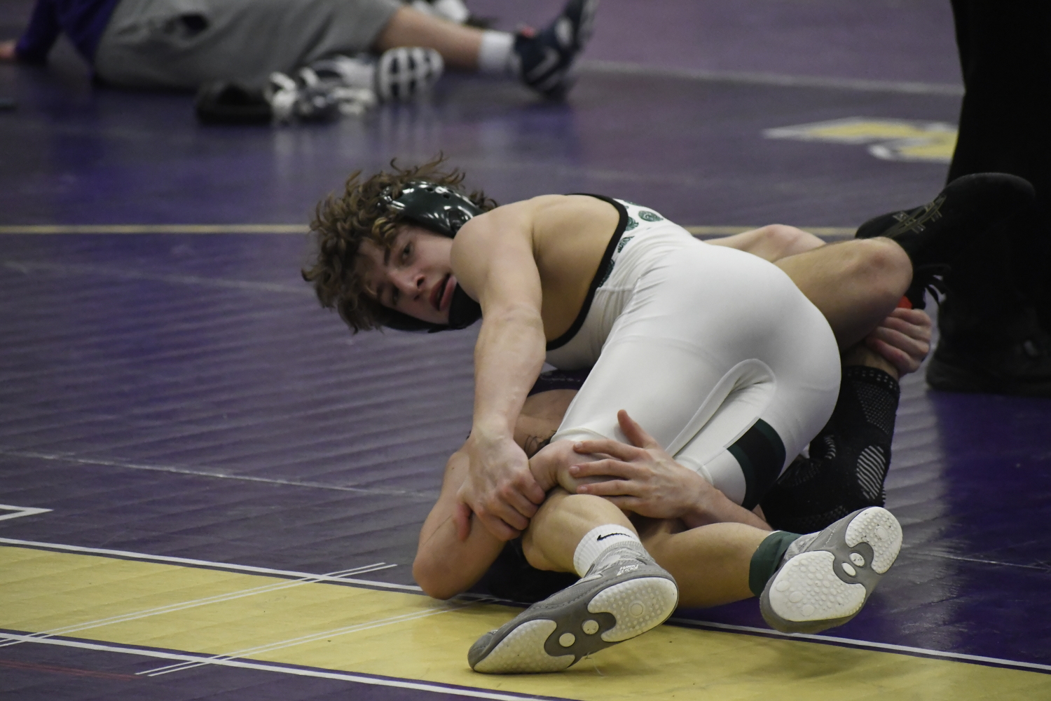 Dylan Blenk takes a quick time check while having Islip's Nico Fallacaro down on the mat.  DREW BUDD