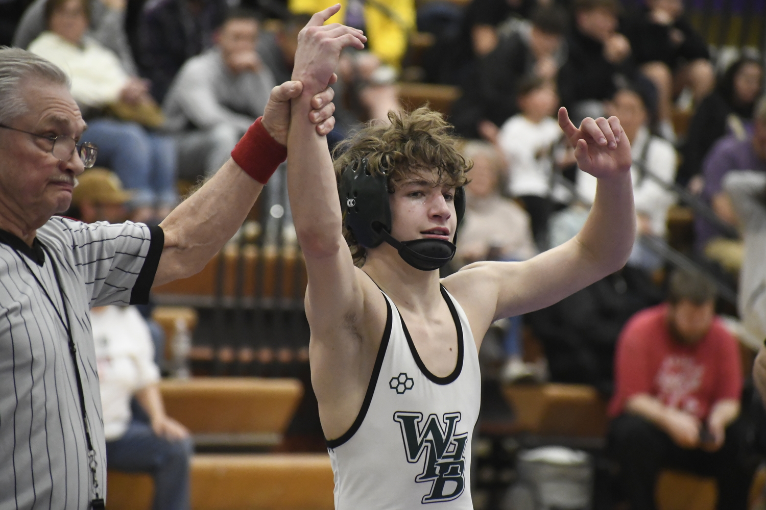 Westhampton Beach sophomore Dylan Blenk gets his arms raised after defeating Islip's Nico Fallacaro, 6-4, to win the League VI title at 108 pounds. DREW BUDD