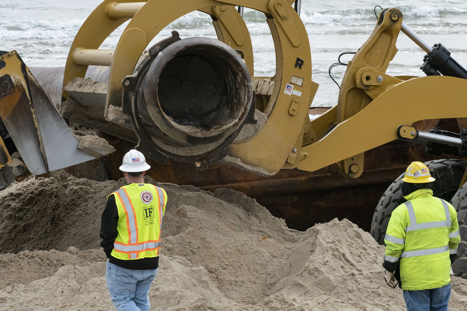 The Great Lakes Dredge & Dock Co. Dredge Co. Texas off Peters Pond on the afternoon of February 11 in Sagaponack ready to pump sand onto the ocean beach.  Here, the pipe is being set in place  just east of Peters Pond on the ocean beach.  DOUG KUNTZ