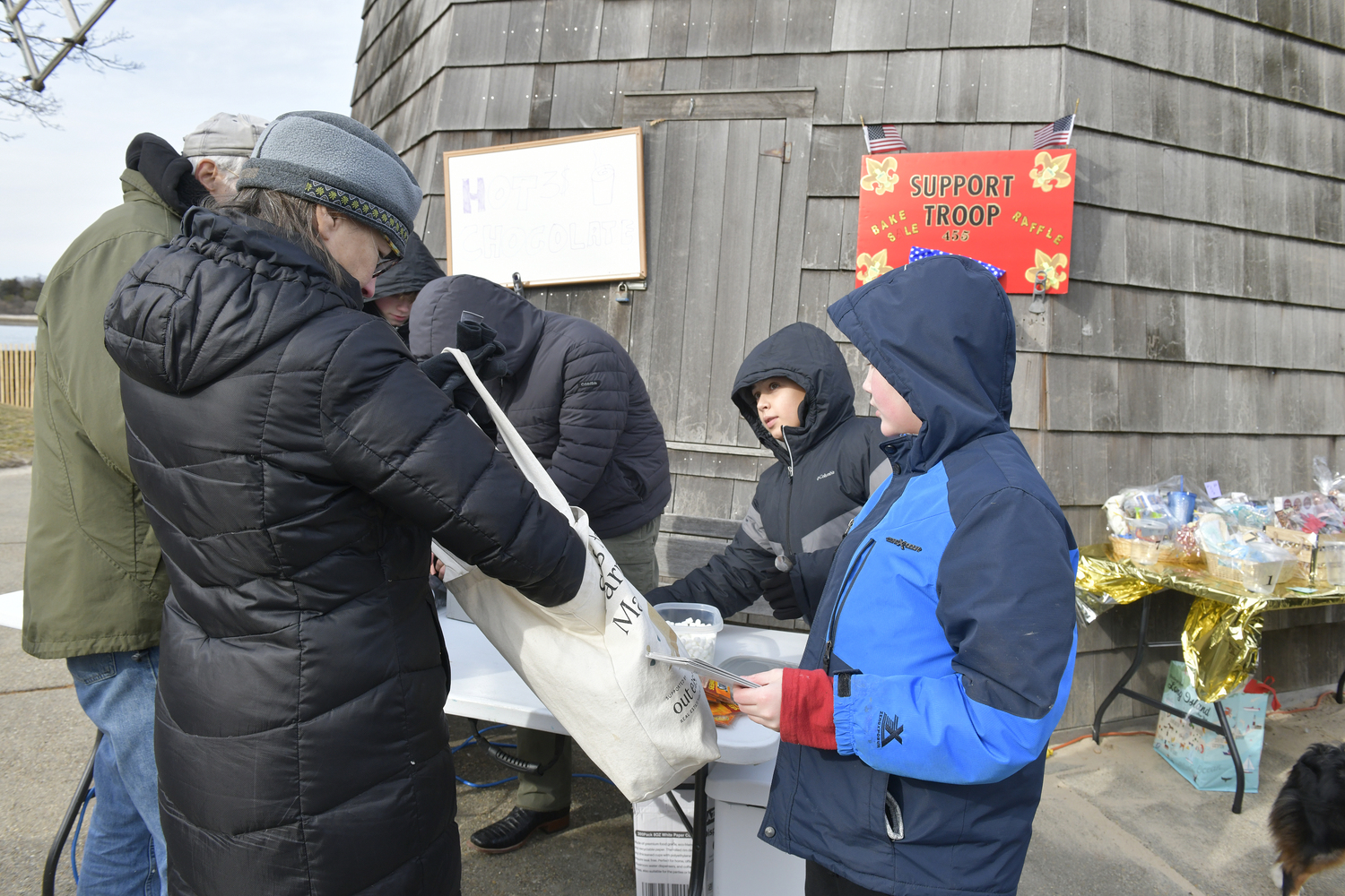 Boy Scout Troop 455 helped HarborFrost attendees keep warm with hot chocolate at the windmill.  DANA SHAW