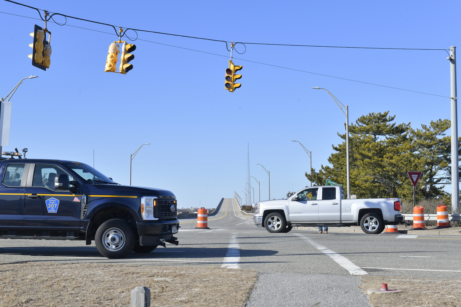 Crews from the NYS DOT block off the south entrance to the Ponquogue Bridge on Friday afternoon after New York State engineers detected signs of weathering in the concrete of at least one of the bridge's supports. DANA SHAW