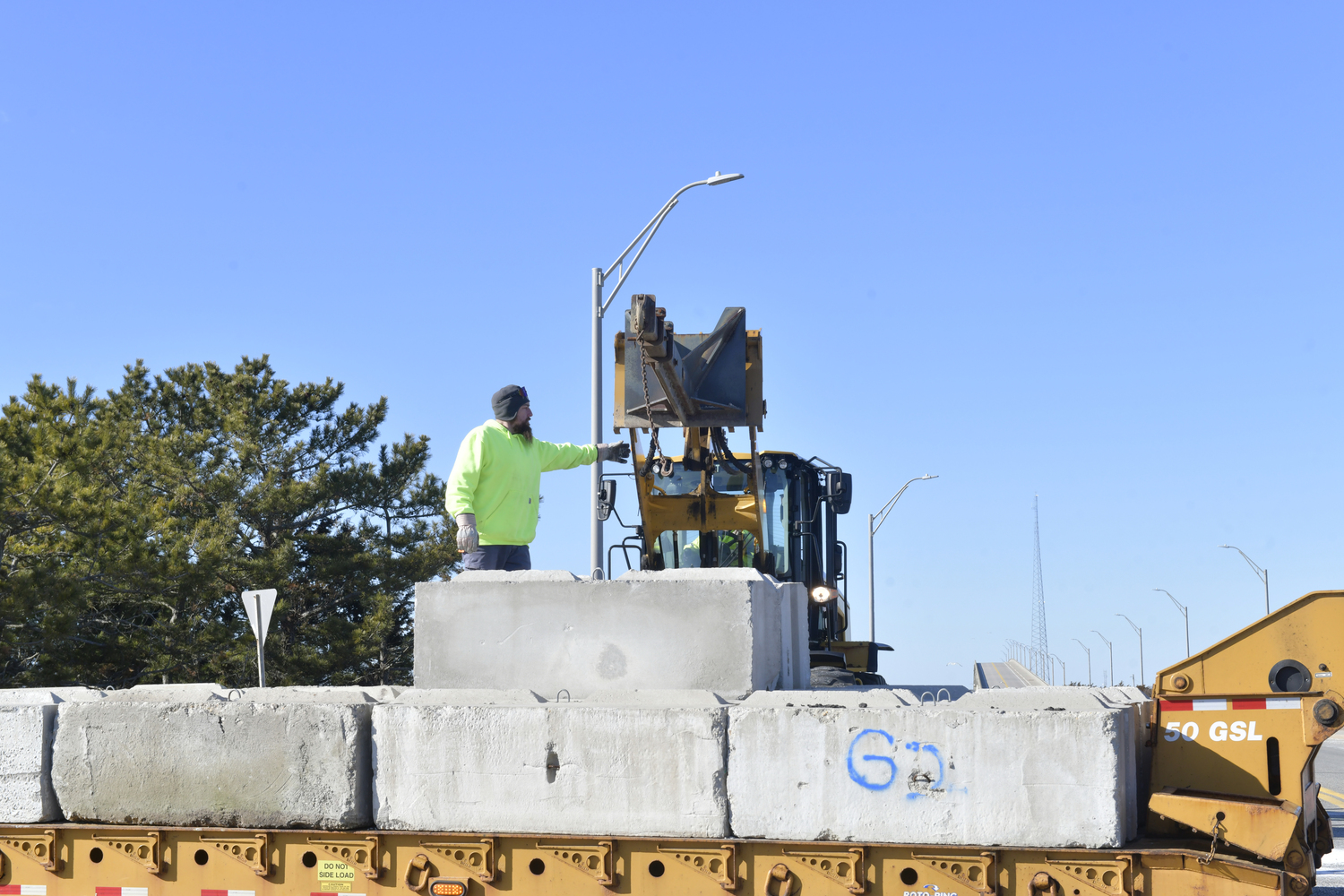 Crews from the NYS DOT block off the south entrance to the Ponquogue Bridge on Friday afternoon after New York State engineers detected signs of weathering in the concrete of at least one of the bridge's supports. DANA SHAW