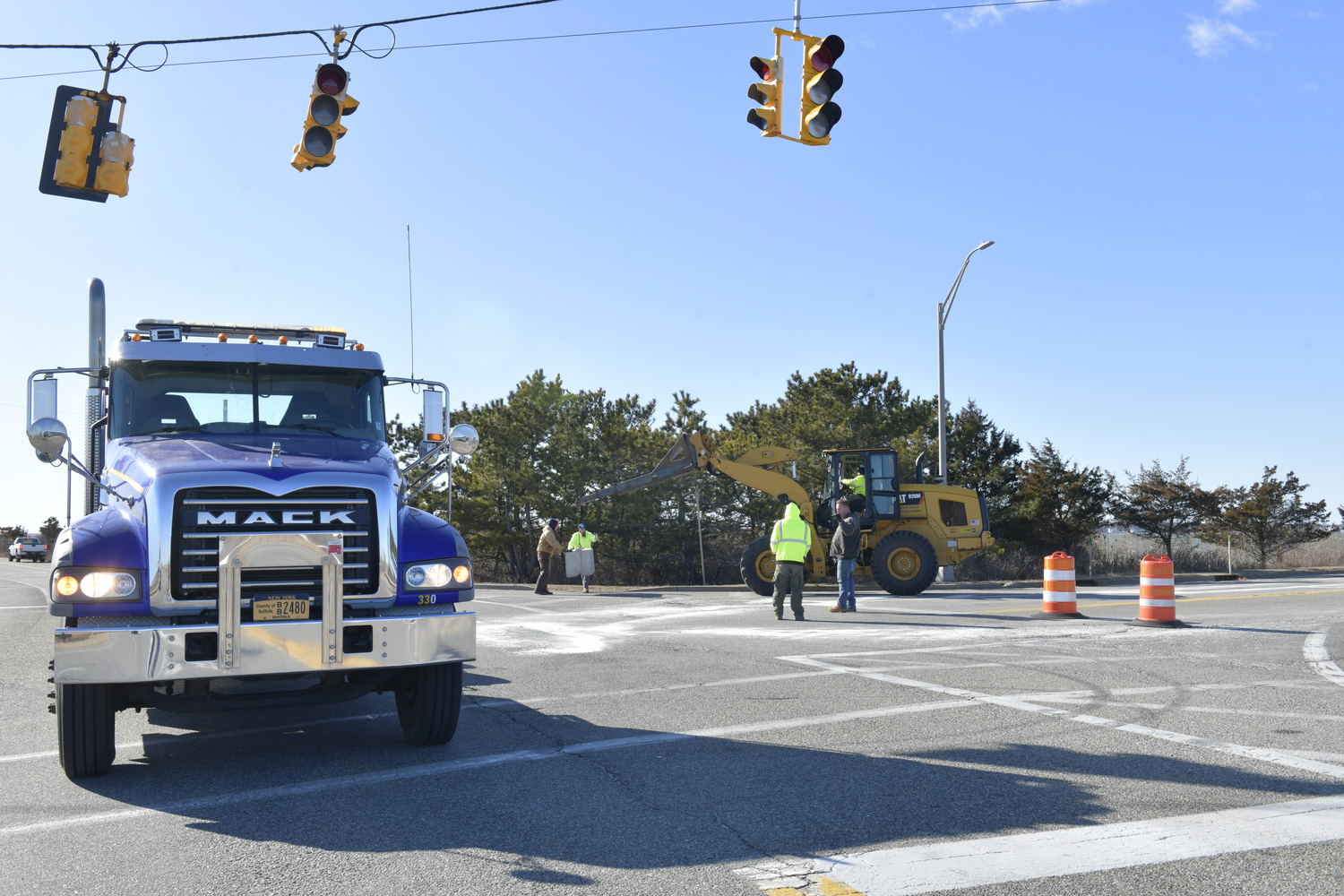 Crews from the NYS DOT block off the south entrance to the Ponquogue Bridge on Friday afternoon after New York State engineers detected signs of weathering in the concrete of at least one of the bridge's supports. DANA SHAW