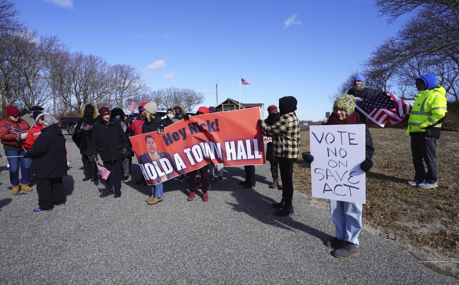 Protesters gathered outside the property at Inlet Seafood restaurant on East Lake Drive on Monday while U.S. Representative Nick LaLota spoke to the media about the dredging of the Montauk inlet.  DOUG KUNTZ