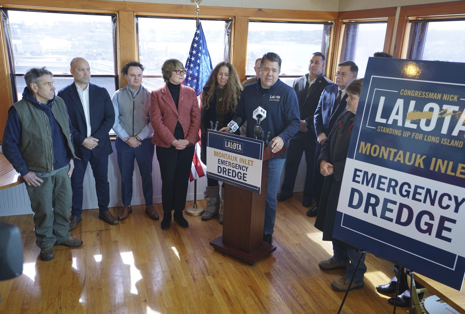 U.S. Representative Nick LaLota speaks to the media about the dredging of the Montauk inlet at Inlet Seafood restaurant on East Lake Drive while protesters walked outside the property line.  DOUG KUNTZ