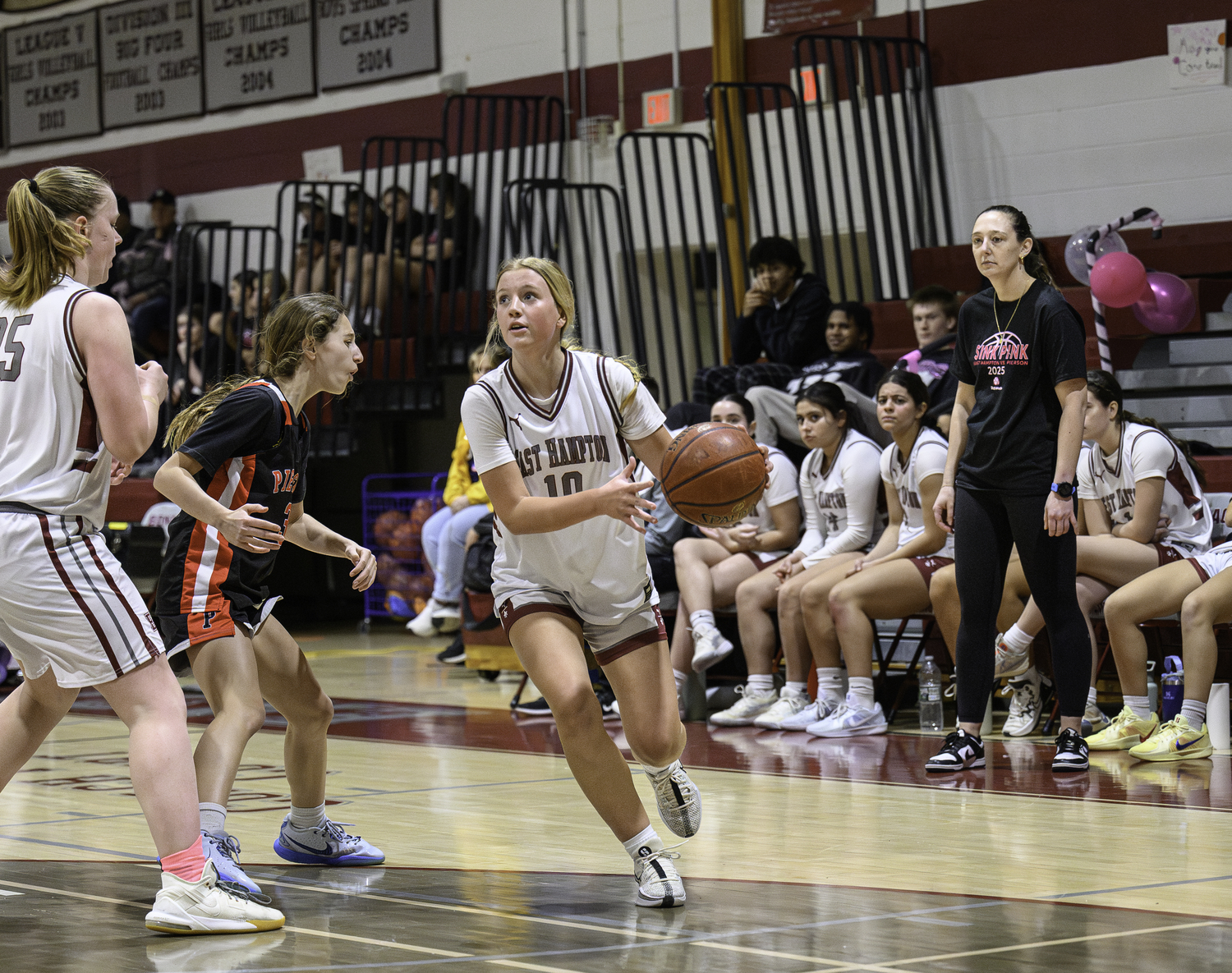 East Hampton junior Lydia Rowan drives to the basket with a pick from senior teammate Susie DiSunno.   MARIANNE BARNETT