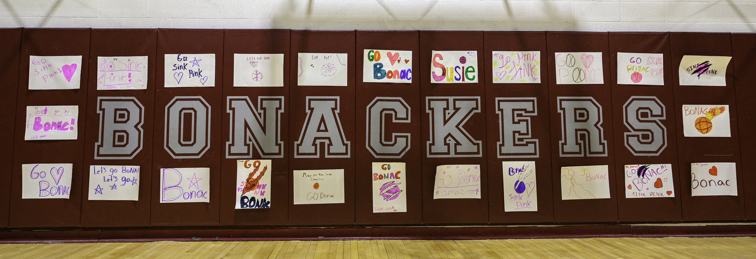 The back walls of the East Hampton High School gym are adorned with homemade signs made for Saturday's Sink Pink game between East Hampton and Pierson.   MARIANNE BARNETT