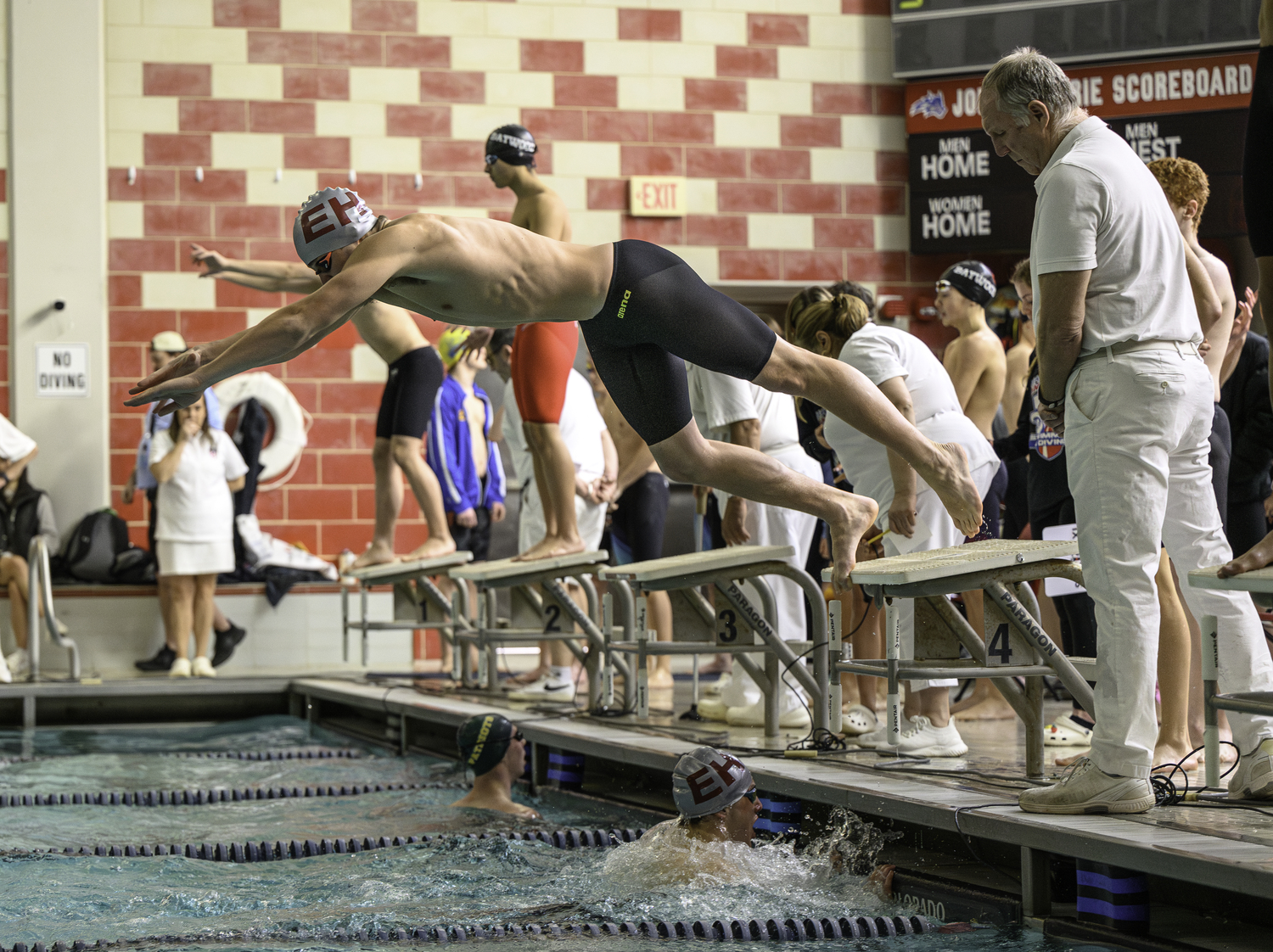 Dylan Knapik dives into the pool at Stony Brook University for the final leg of the 200-yard medley relay.   MARIANNE BARNETT