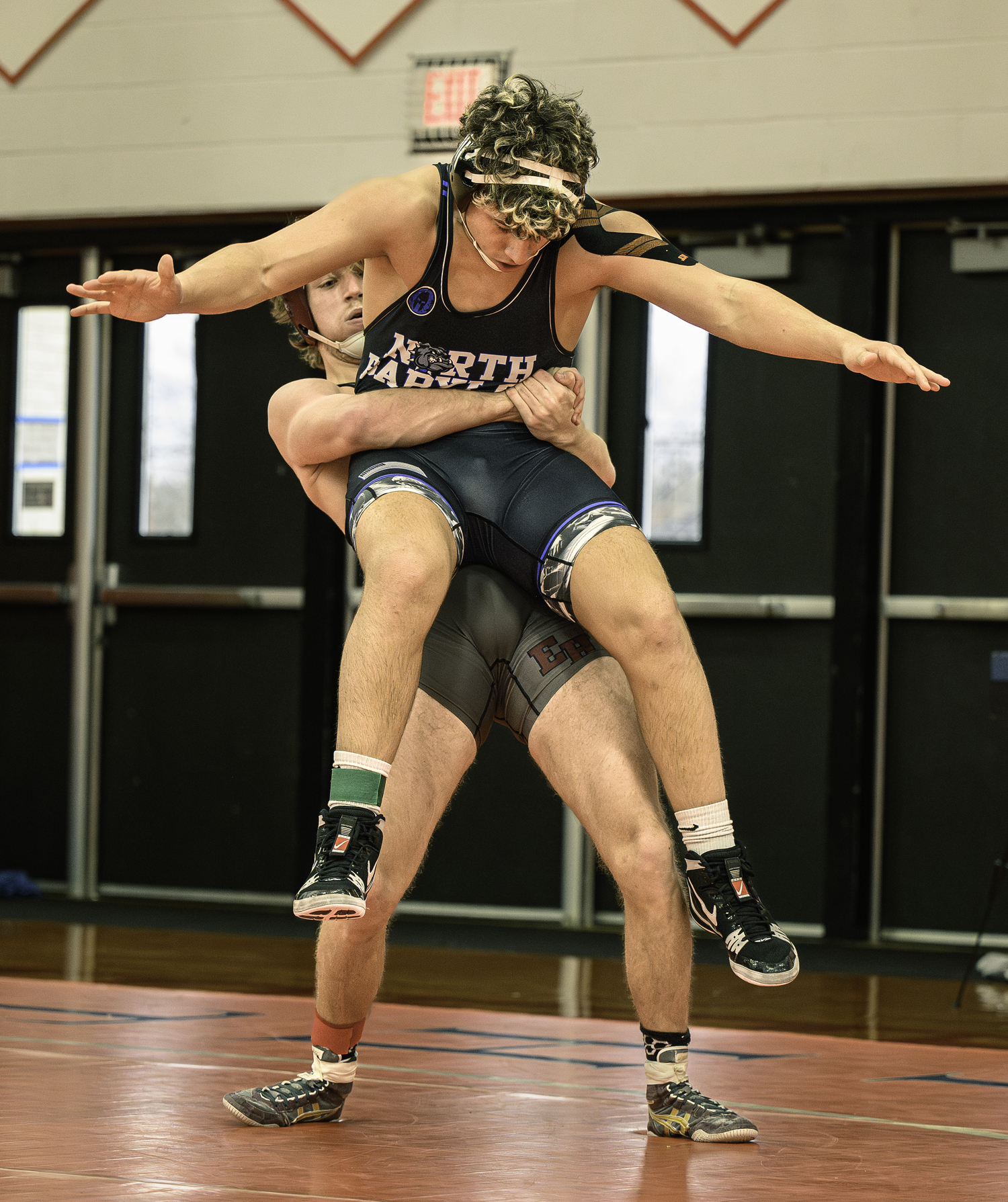 East Hampton senior Adam Beckwith picks up North Babylon's Luca Turano in the semifinals.   MARIANNE BARNETT