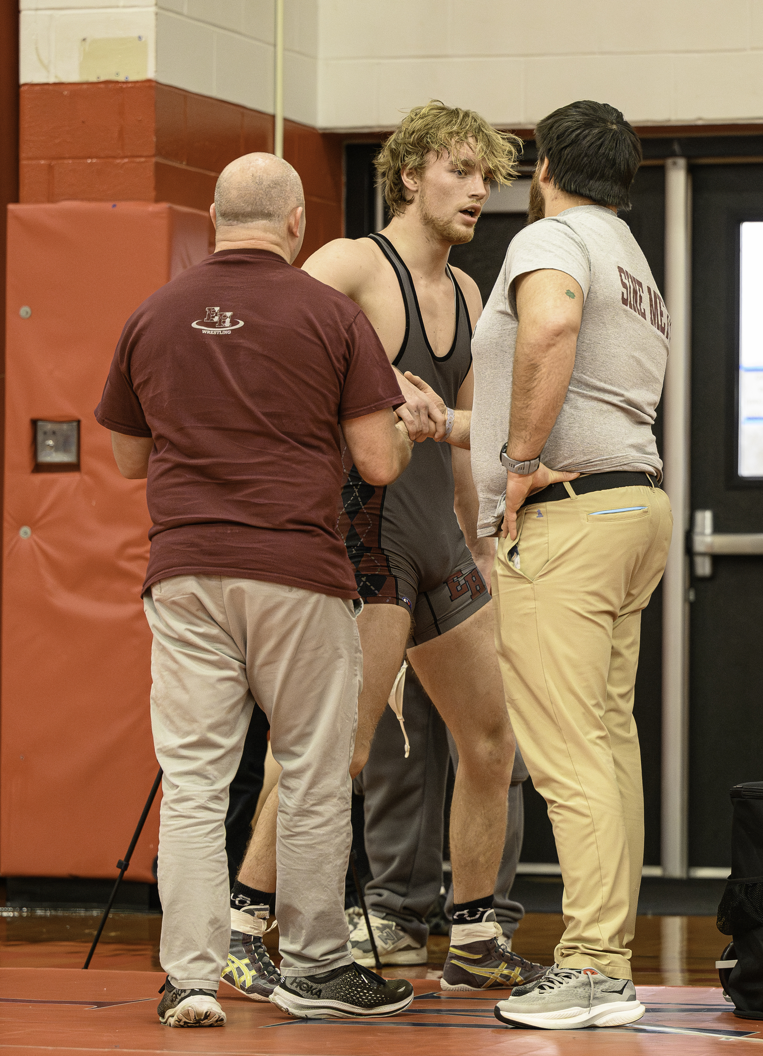 East Hampton senior Adam Beckwith is congratulated by head coach Ethan Mitchell and assistant coach Greg Schaffer.   MARIANNE BARNETT