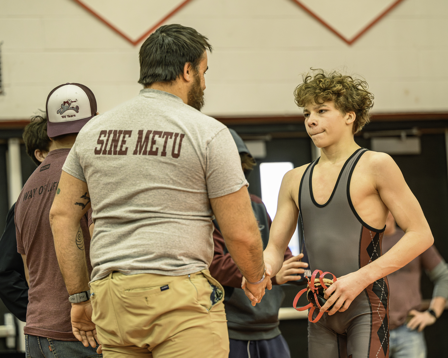 East Hampton head coach Ethan Mitchell congratulates Austin Bronco Campsey after one of his man victories on Saturday at the League III Championships.   MARIANNE BARNETT