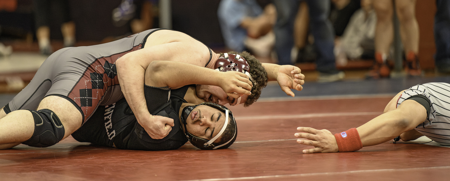 East Hampton junior Franco Palombino scores back points on Newfield's Khriztopher Gonzalez in the semifinals.   MARIANNE BARNETT