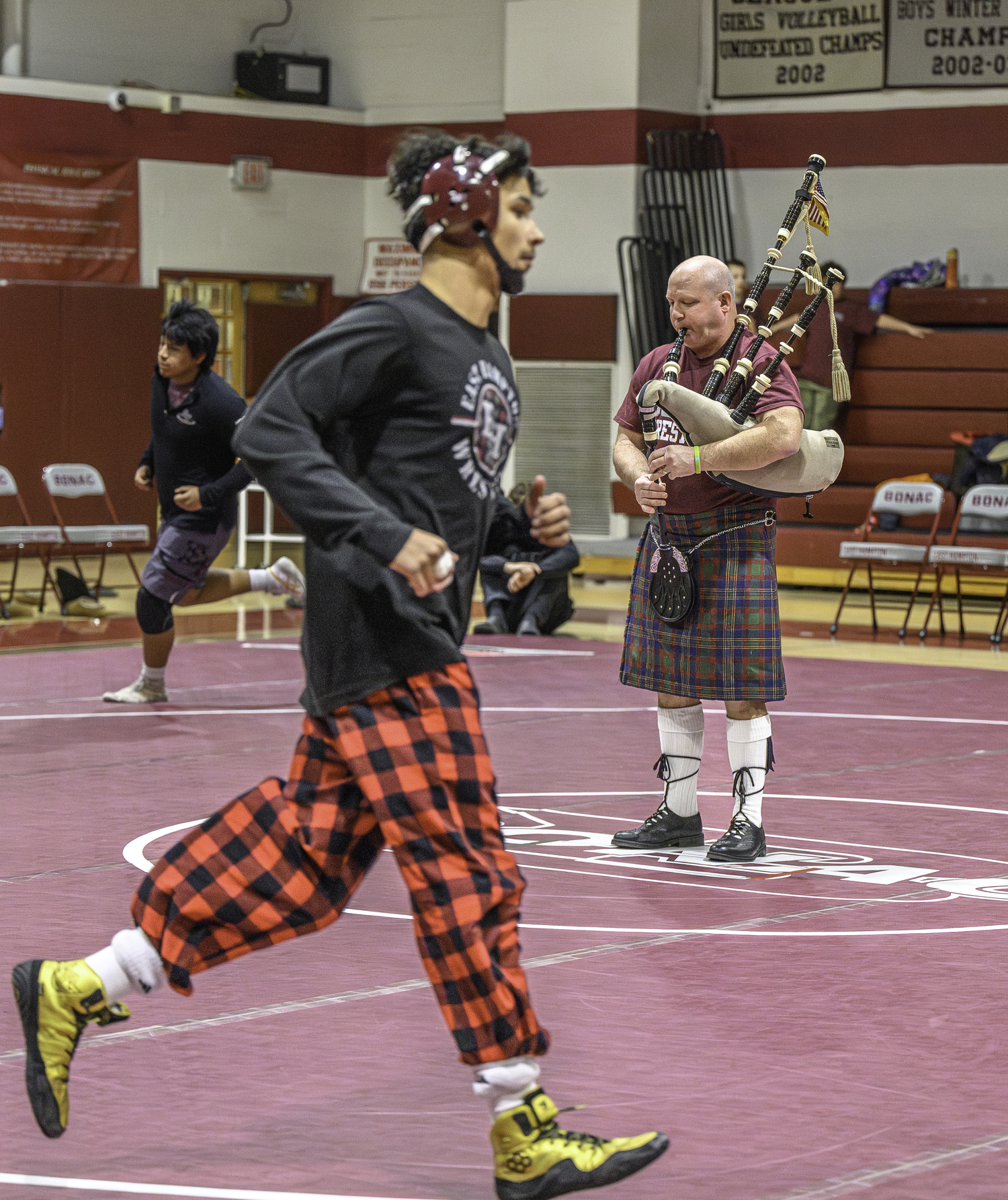 Assistant coach  led the Bonackers onto the mat for their Senior Night Bonac Duals on Thursday, January 30.   MARIANNE BARNETT