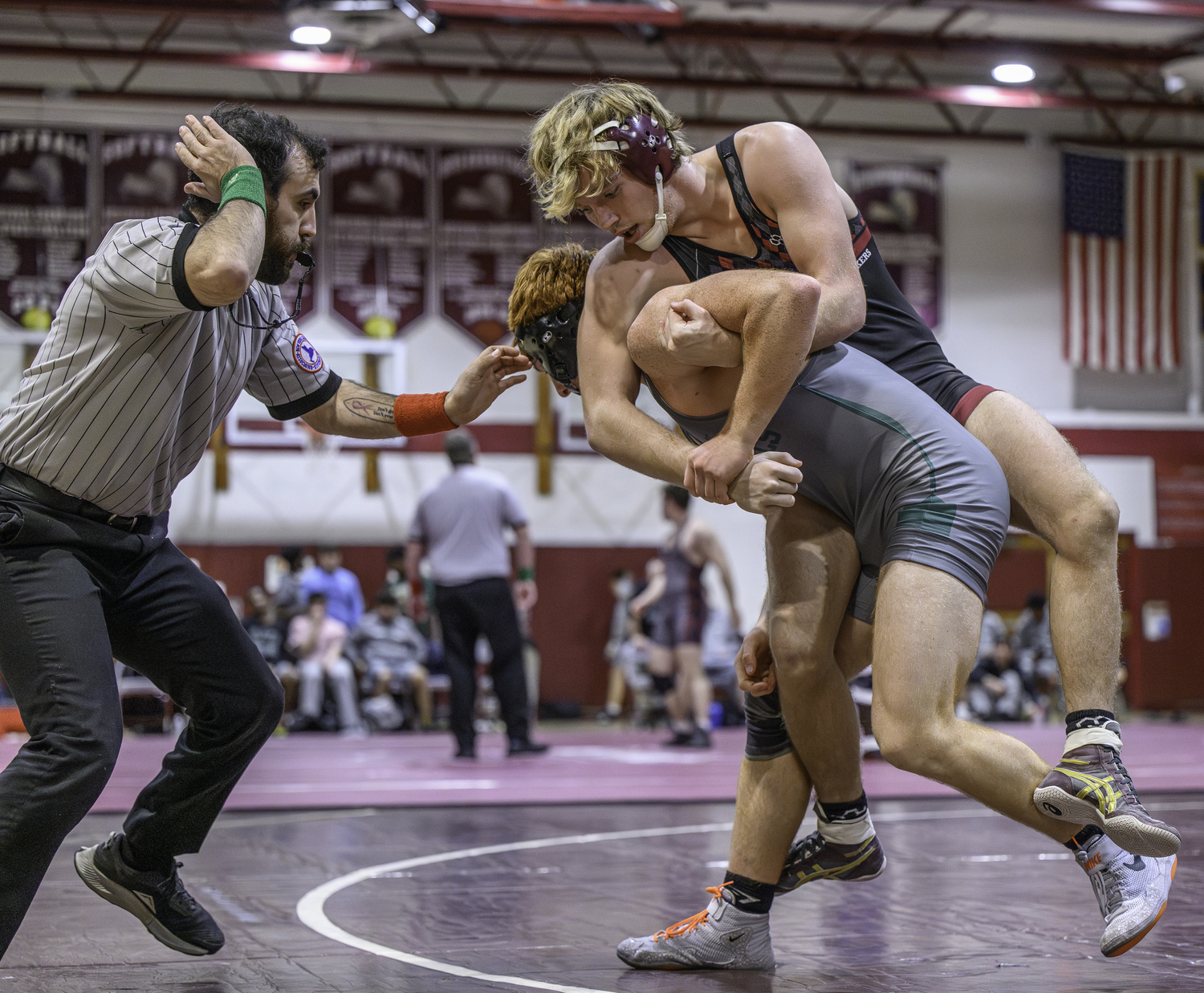 East Hampton senior Adam Beckwith hangs on to William Floyd's David Gonzalez.   MARIANNE BARNETT