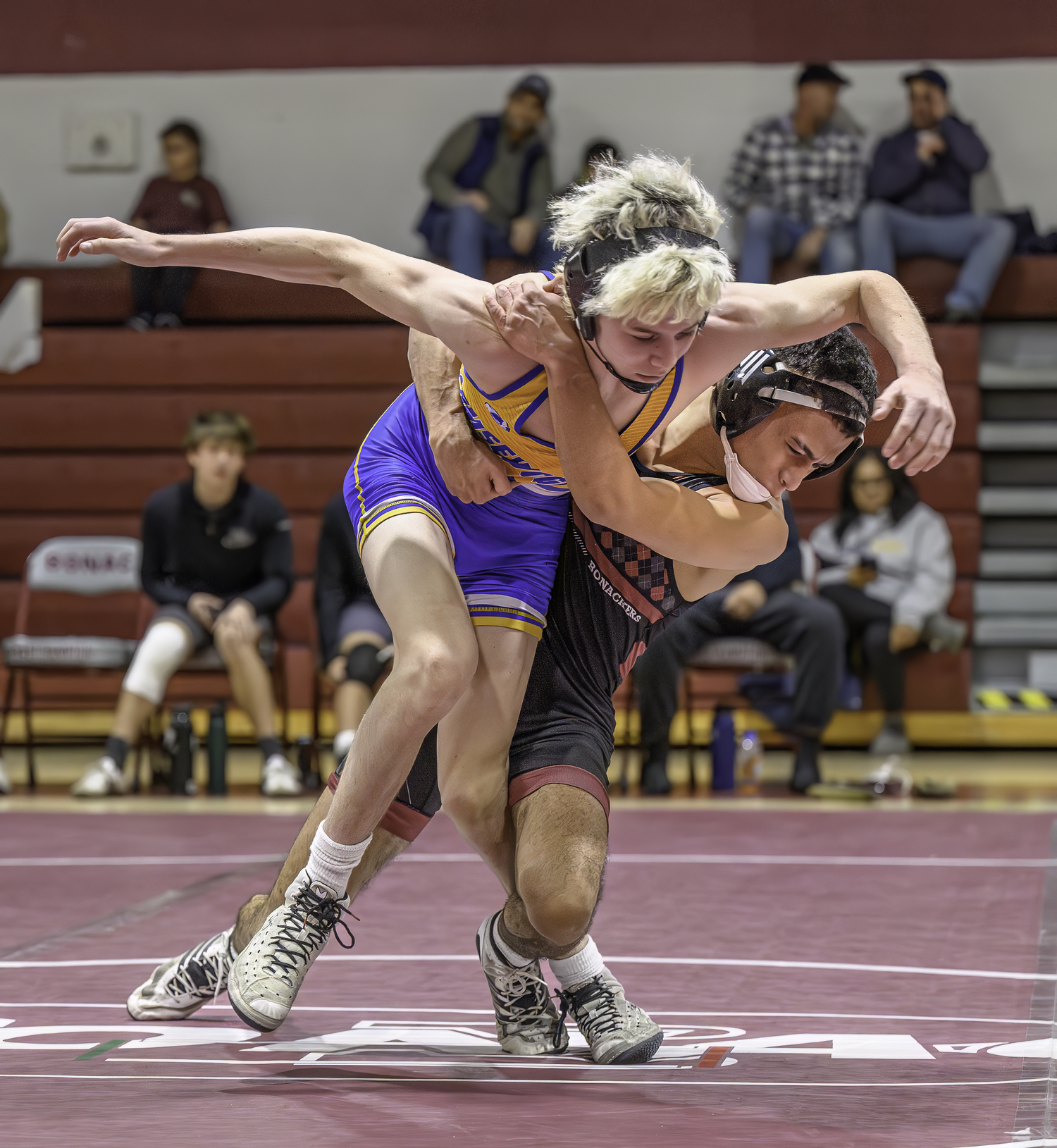 East Hampton senior Josue Elias takes down Comsewogue's Collin Schmalz.  MARIANNE BARNETT