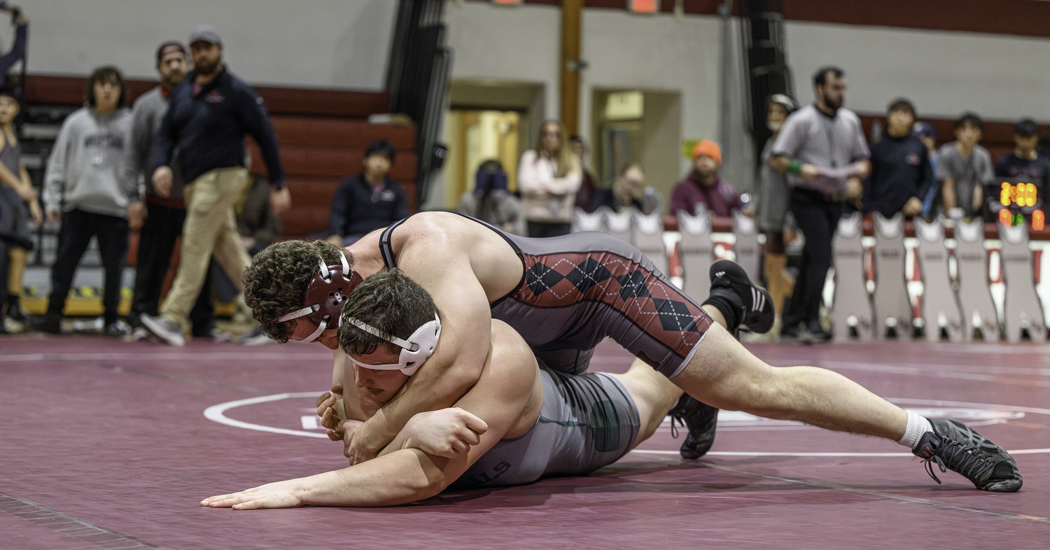 East Hampton's Francesco Palombino has top control and tries to get a crossface in on William Floyd's Angelo Franzese.   MARIANNE BARNETT