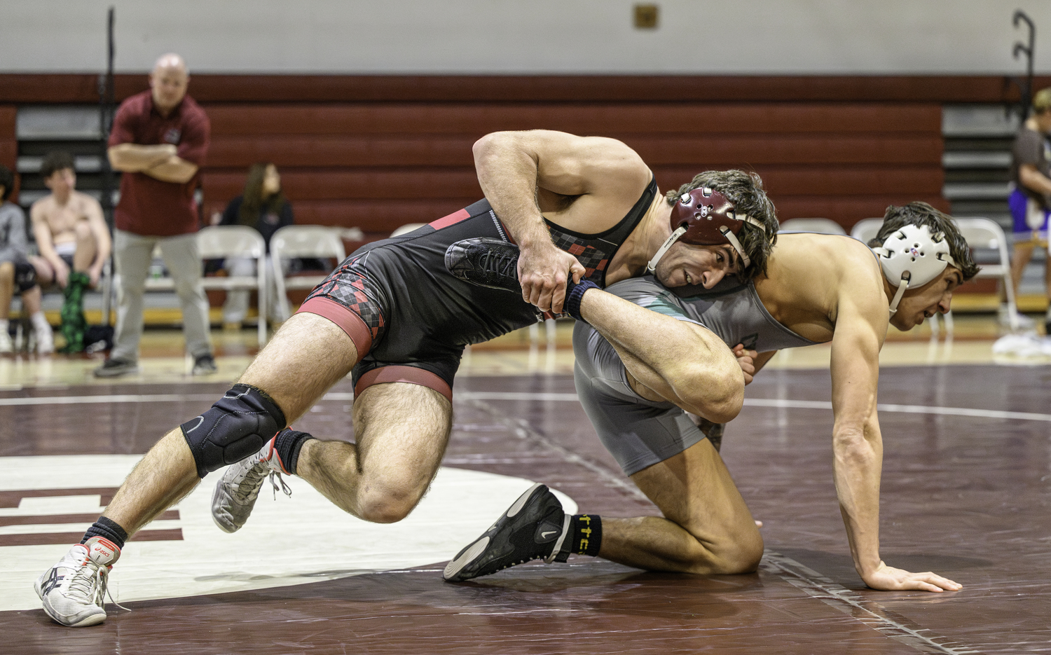 East Hampton senior Justin Prince tries to drive down William Floyd's Antonio Martin to the mat.  MARIANNE BARNETT