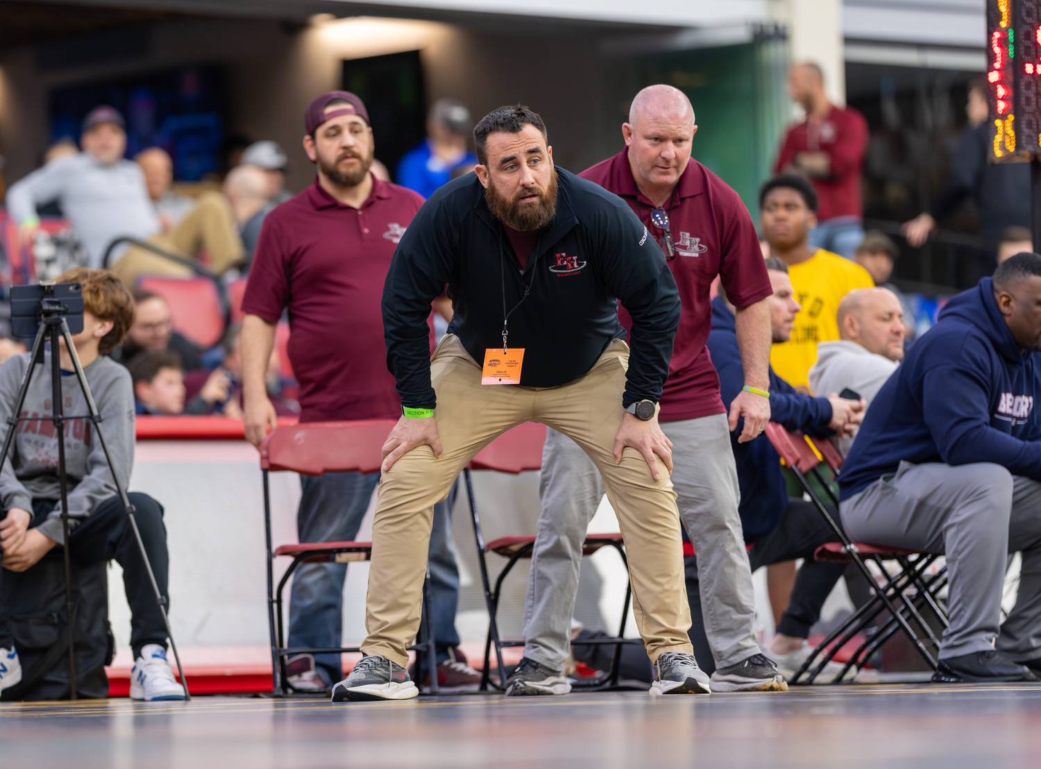 Bonac coaches Cory Strain and Greg Schaefer look on with head coach Ethan Mitchell.   RON ESPOSITO