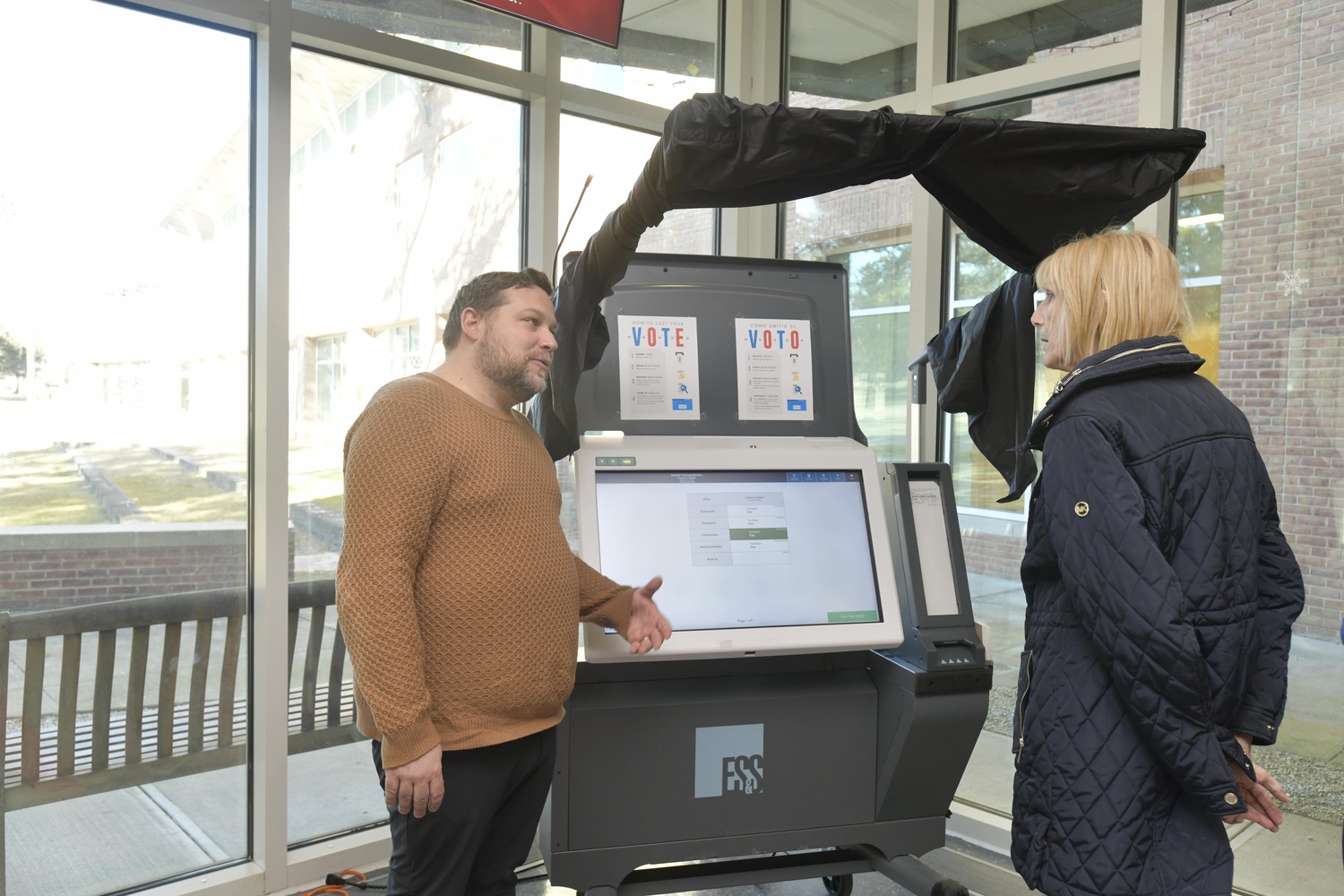 Matt Lewandowski from election Systems and Software demonstrates new voting machines to Diana Carpenter of East Quogue on Saturday in Chancellor's Hall at the Stony Brook Southampton Campus. Other demonstration times and dates include: Westhampton VFW Post 5350, Saturday, 11 a.m. to 2 p.m. and 4 p.m. to 8 p.m.; Southampton Arts Center, Sunday, 1 p.m. to 5 p.m.; Hampton Bays Senior Center,
Thursday, March 6, 11:30 a.m. to 3:30 p.m.
The new machines will be used at the March 18, special Southampton Town Election.  DANA SHAW