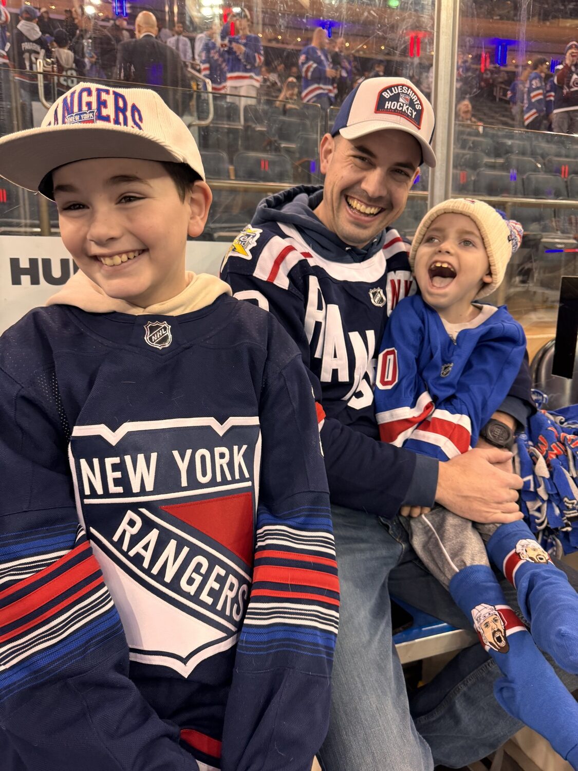 From left, Cooper, Alex and Hunter Gladding in the Rangers penalty box before the start of the game.