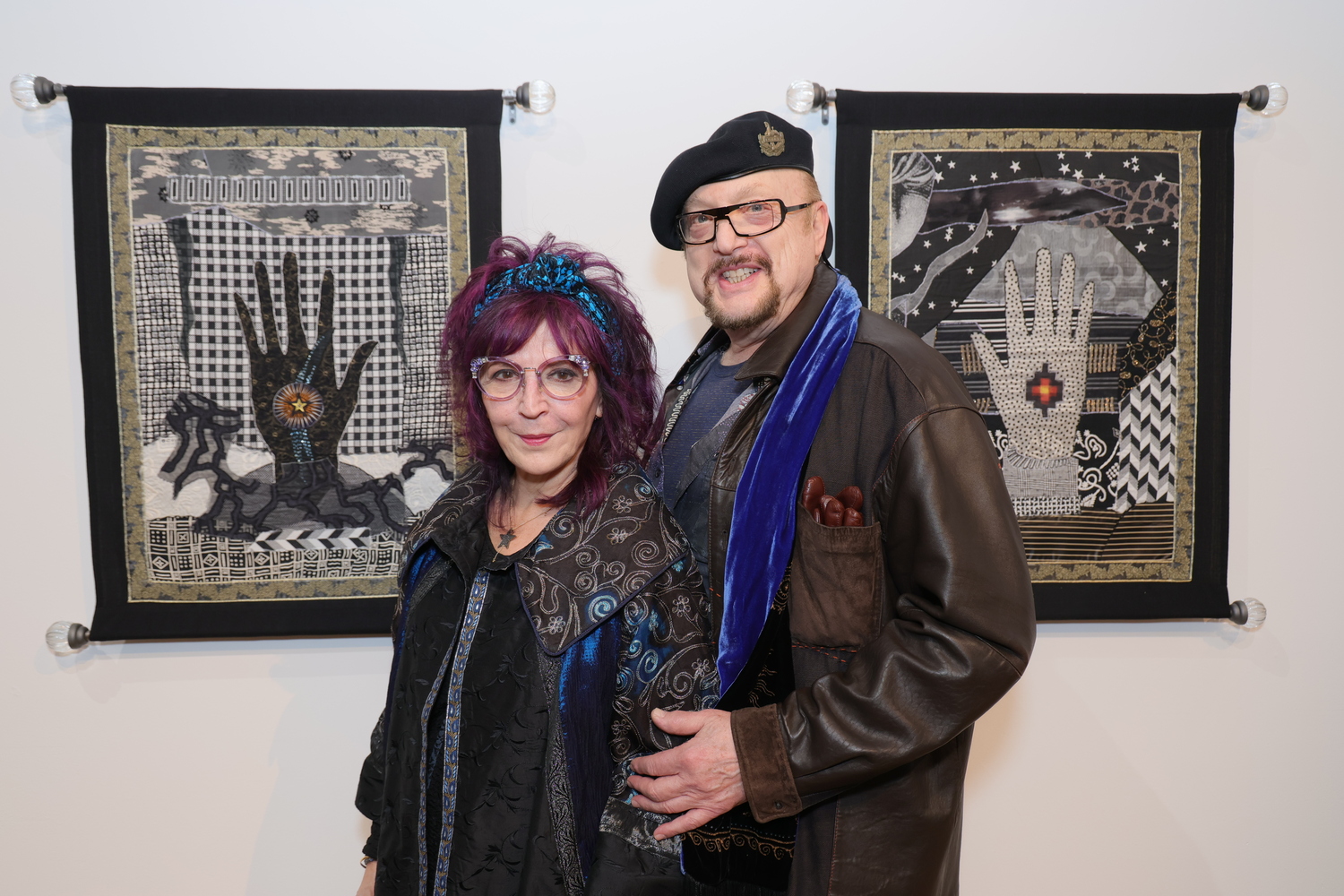 Artist Amy Zerner with artwork and her husband Monte Farber at the opening of 