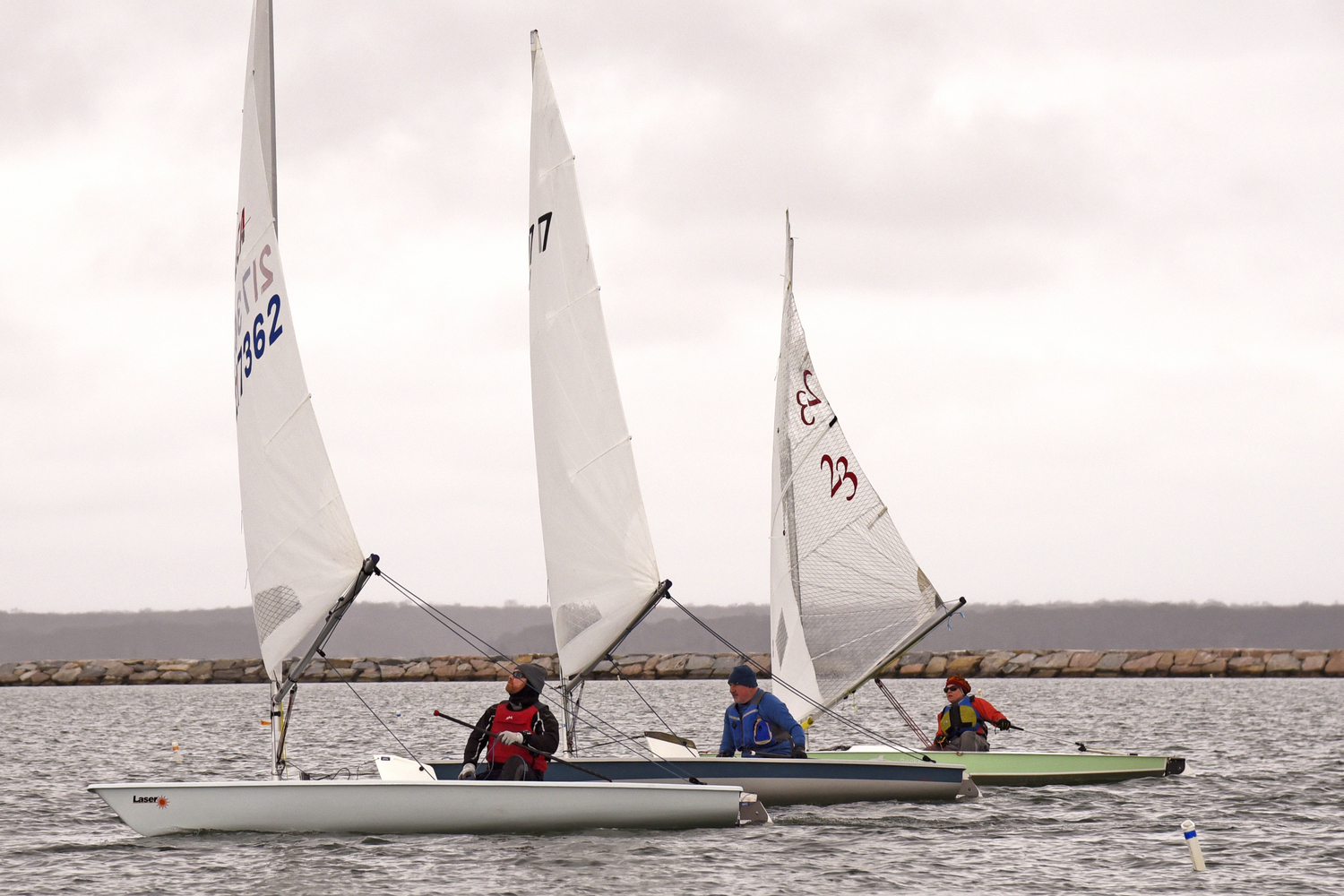 From left, Peter Beardsley, who finished first overall in the six races, ahead of Ian Welch and rocket skipper Gloria Maroti Frazee. As this photo testifies, a rocket is quite competitive against the faster lasers.  MICHAEL MELLA