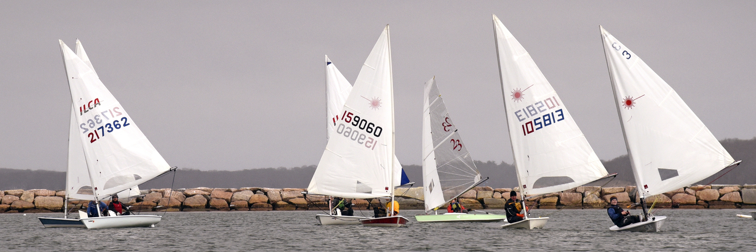 The fleet after rounding the windward mark, half of which is visible to the right of laser 105813’s mast, in the final race of the day.   MICHAEL MELLA