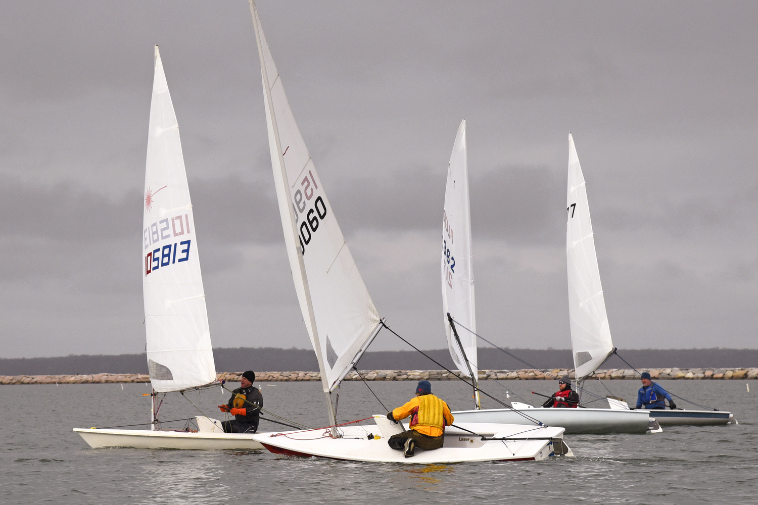 On a downwind leg to the gybe mark, dagger boards up, from left: Rudy Ratsep, Derrick Galen, Peter Beardsley and Ian Welch.   MICHAEL MELLA