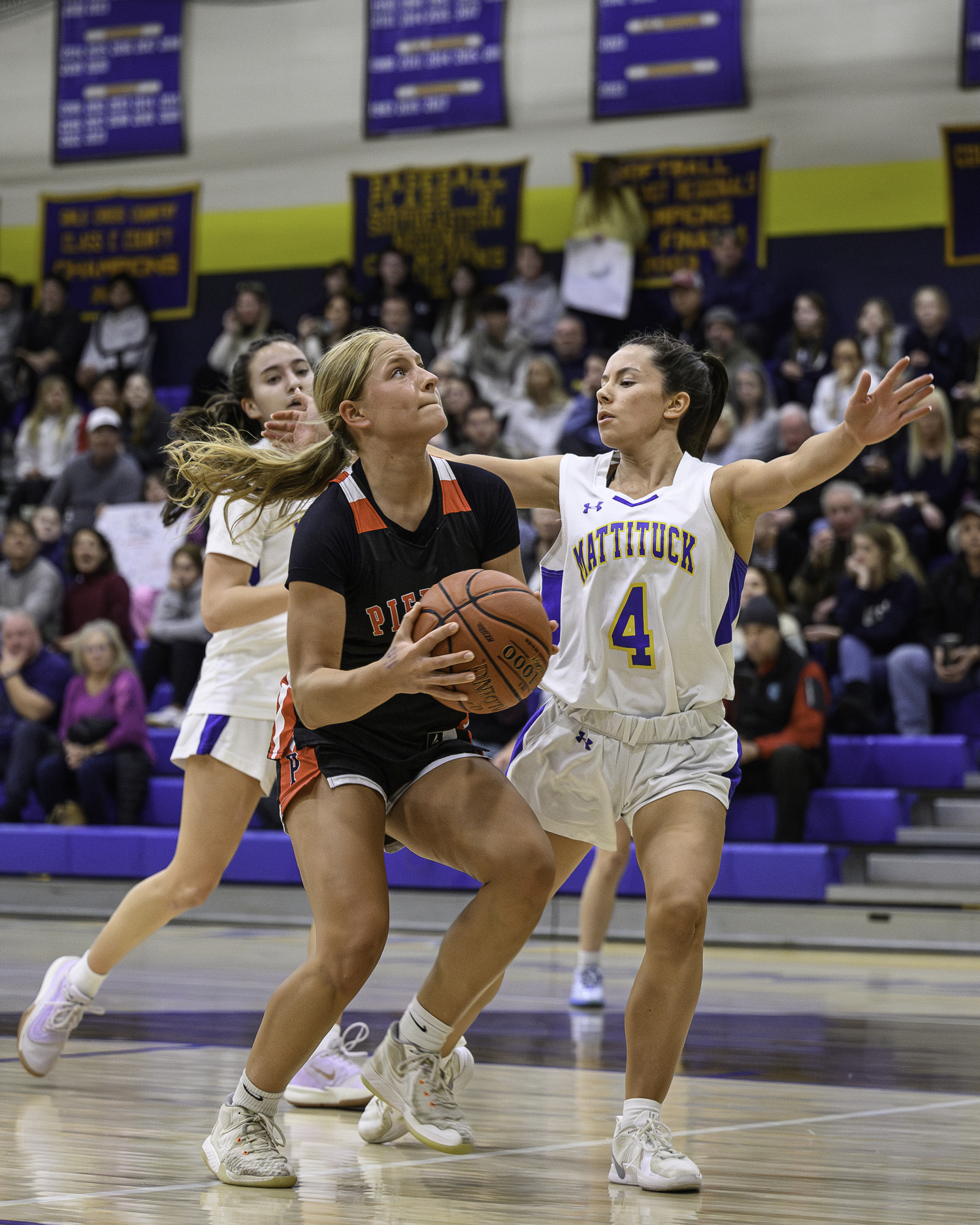 Lola Eldridge tries to go up against Mattituck's McKenna Clarke.   MARIANNE BARNETT