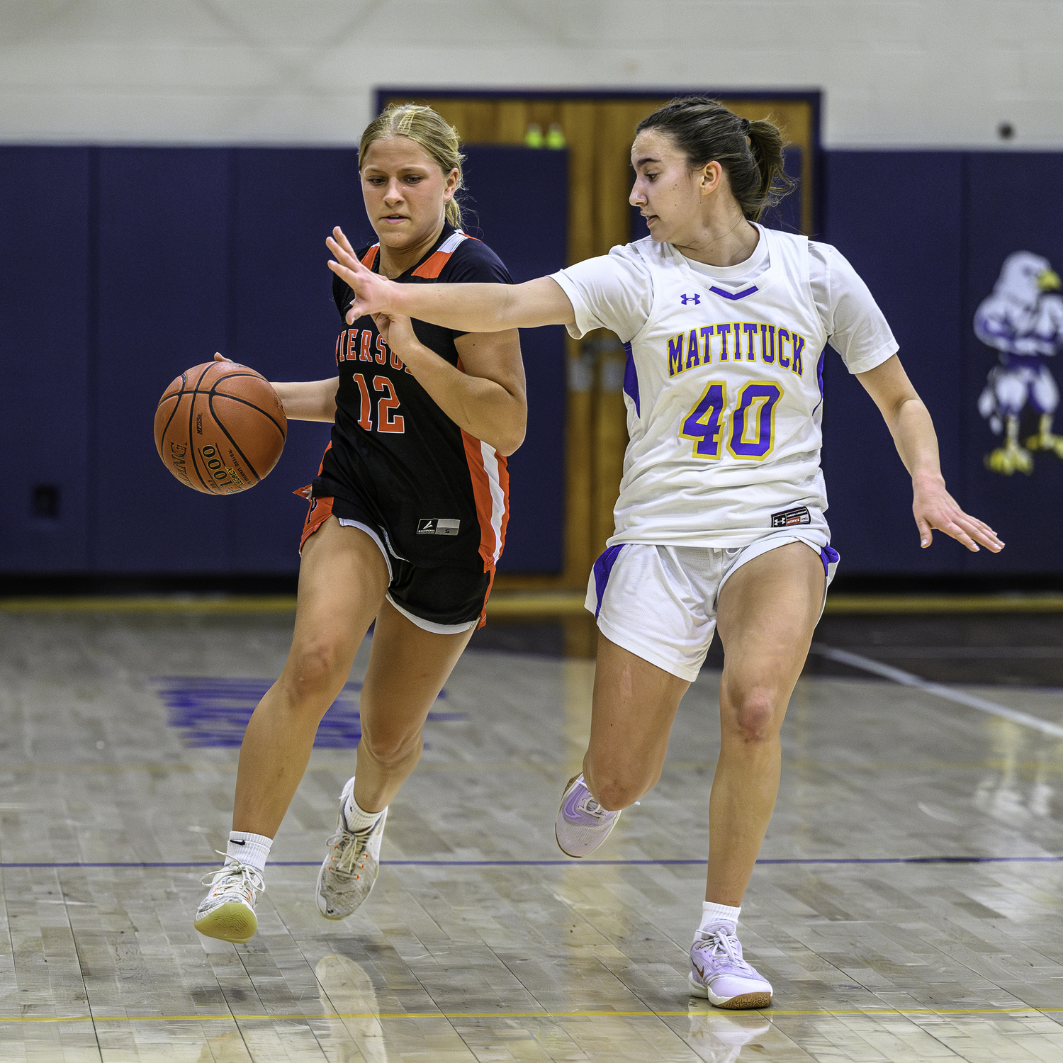 Pierson's Lola Eldridge tries to fend of Mattituck's Page Kellershon.   MARIANNE BARNETT