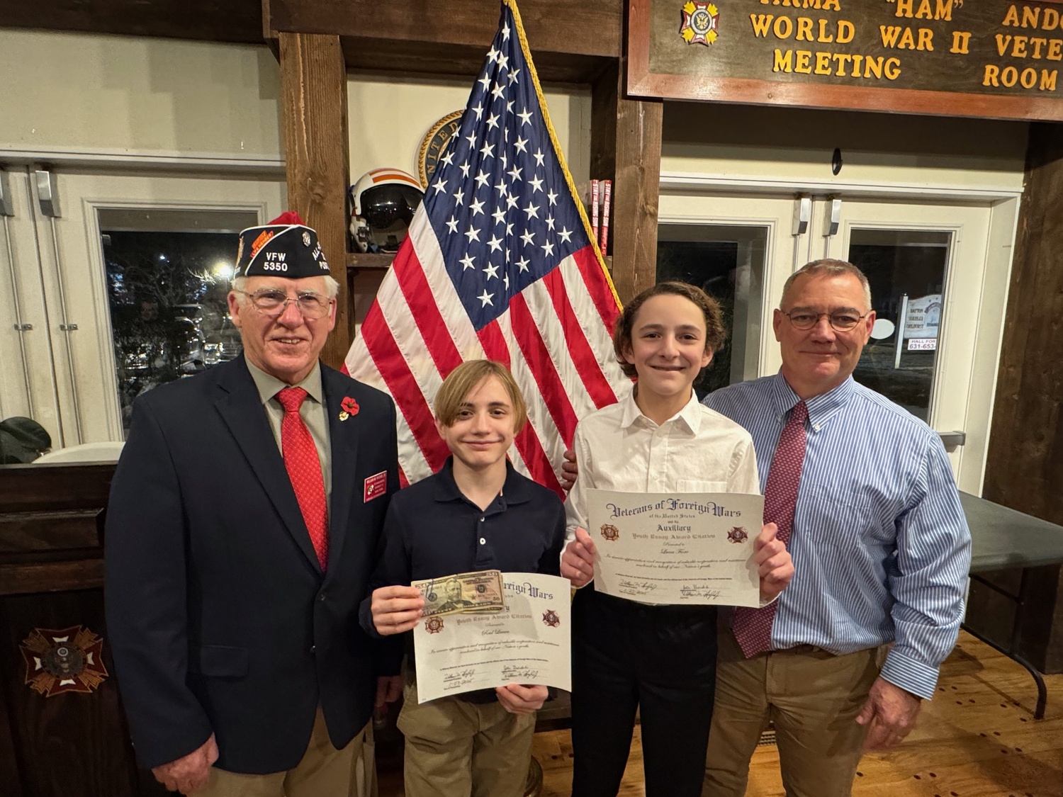 East Quogue students Lucas Fiore and Reid Larsen wrote winning Patriot’s Pen Award essays in the Voice of Democracy contest sponsored by the Veterans of Foreign Wars Post #5530 in Westhampton Beach. With the students are VFW Post 5350 Commander William Hughes, left, and Lucas’s father, Paul Fiore. COURTESY EAST QUOGUE SCHOOL DISTRICT