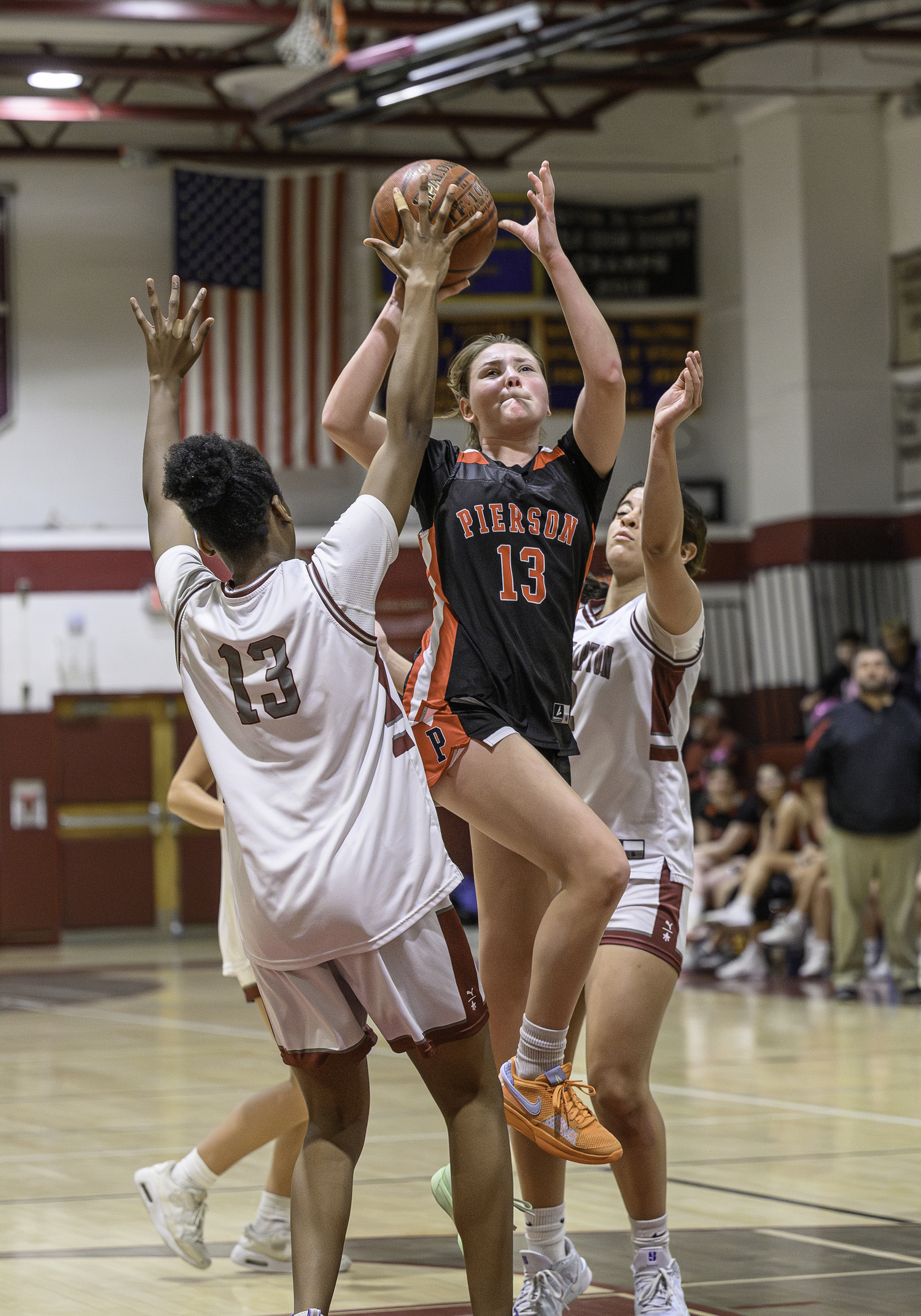 Pierson senior Cali Wilson battles through a pair of Bonackers as she goes up for two points.  MARIANNE BARNETT