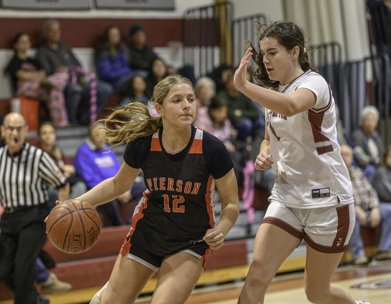 Pierson's Lola Eldridge drives on East Hampton's Colleen McKee.   MARIANNE BARNETT