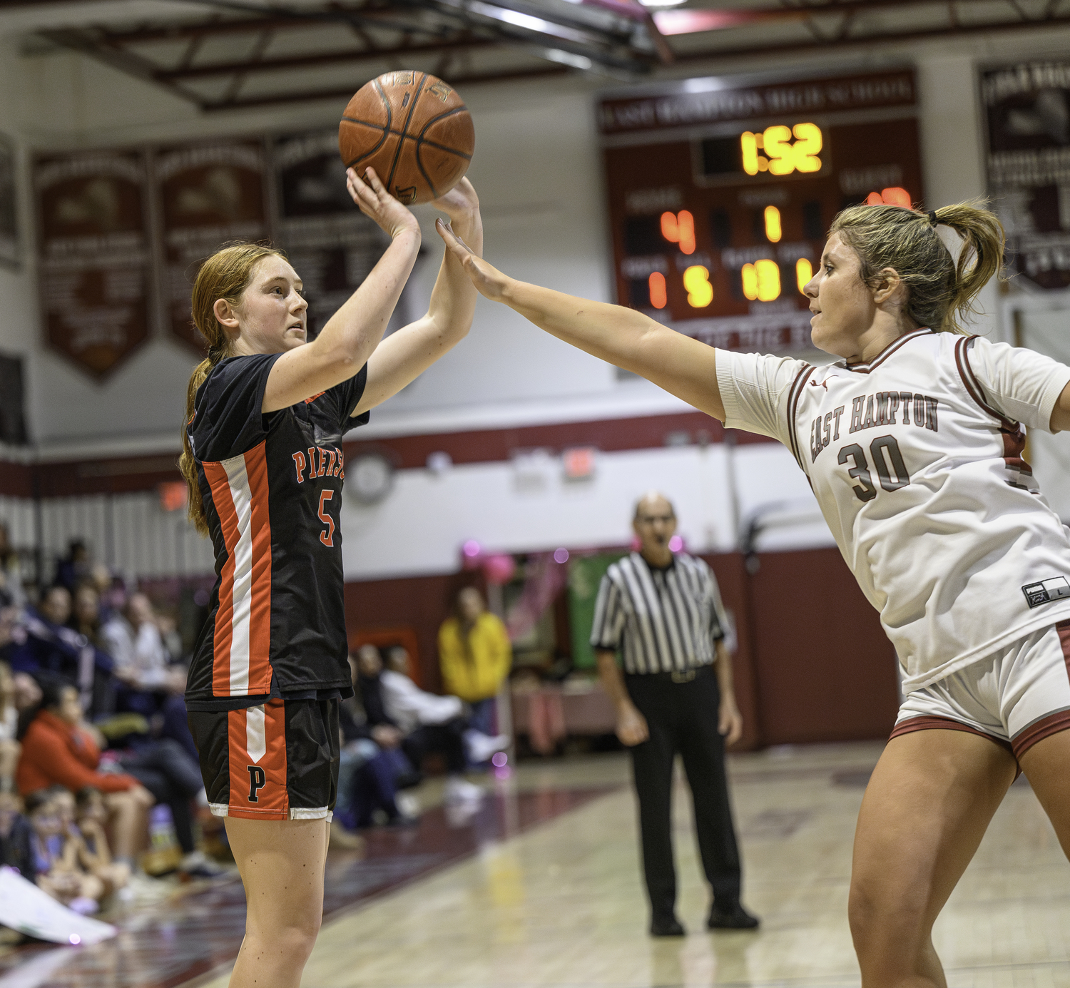 Josie Mott shoots a three with a hand in her face.  MARIANNE BARNETT