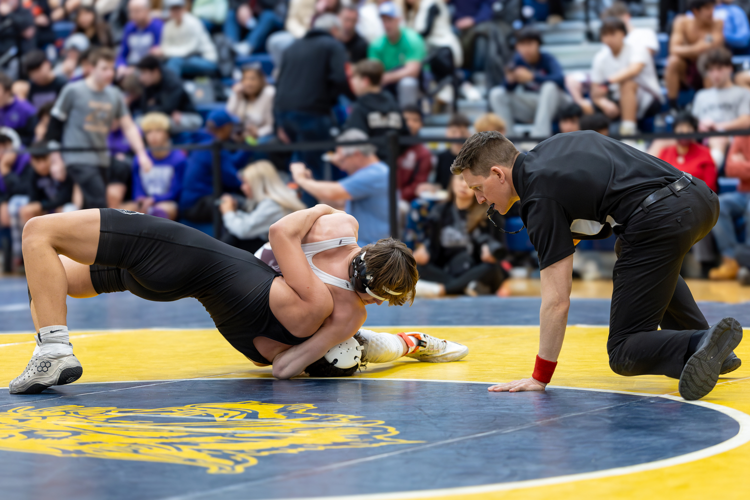 Southampton senior Hudson Fox has one of his opponents in a headlock.  RON ESPOSITO