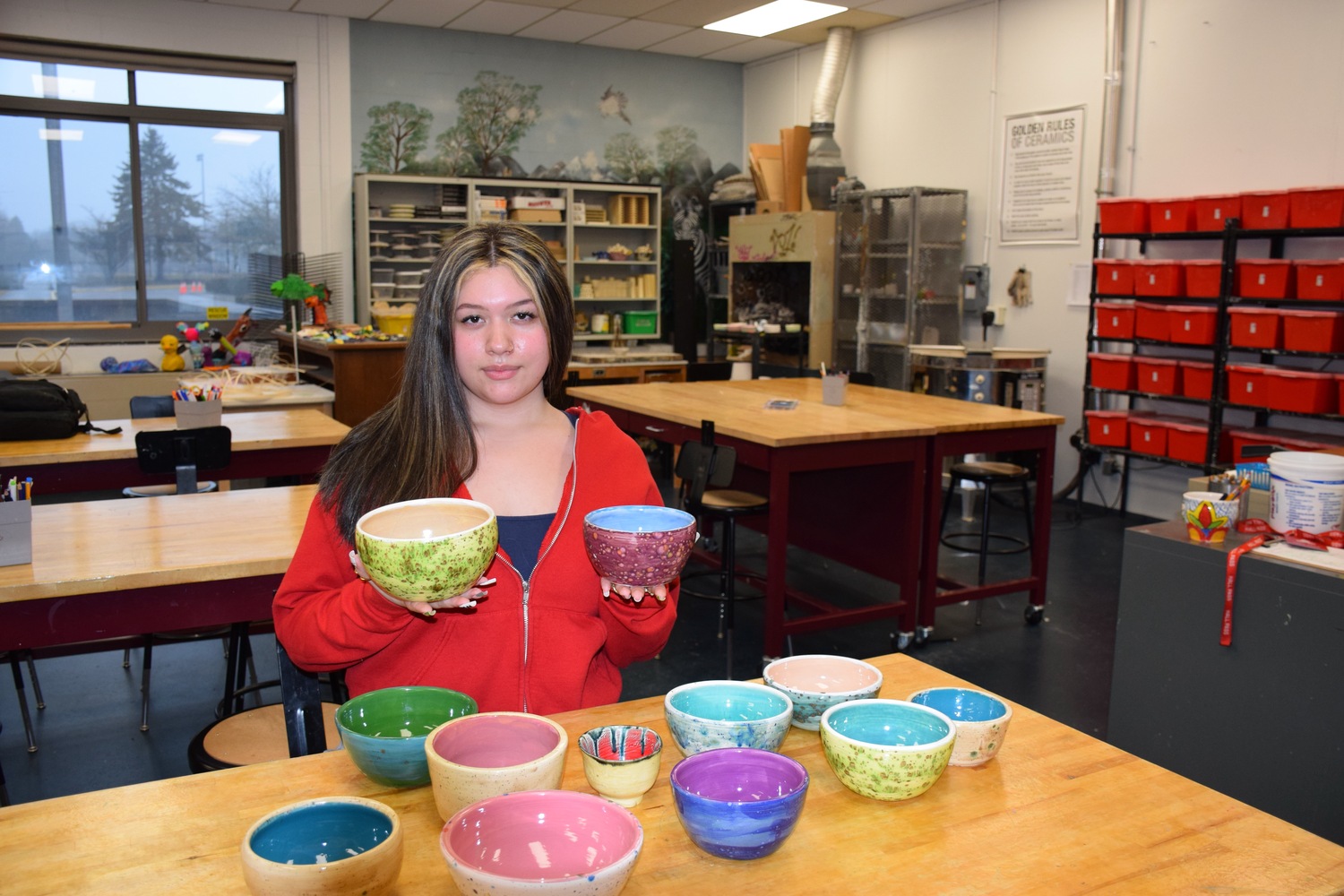 Southampton High School art student Donna Alvarez with the bowl she crafted as part of a class 