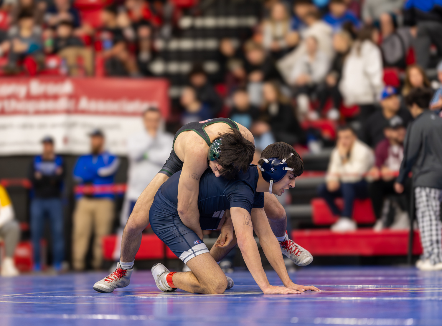 Westhampton Beach junior Carmine Esposito hangs on to this Smithtown West opponent.   RON ESPOSITO