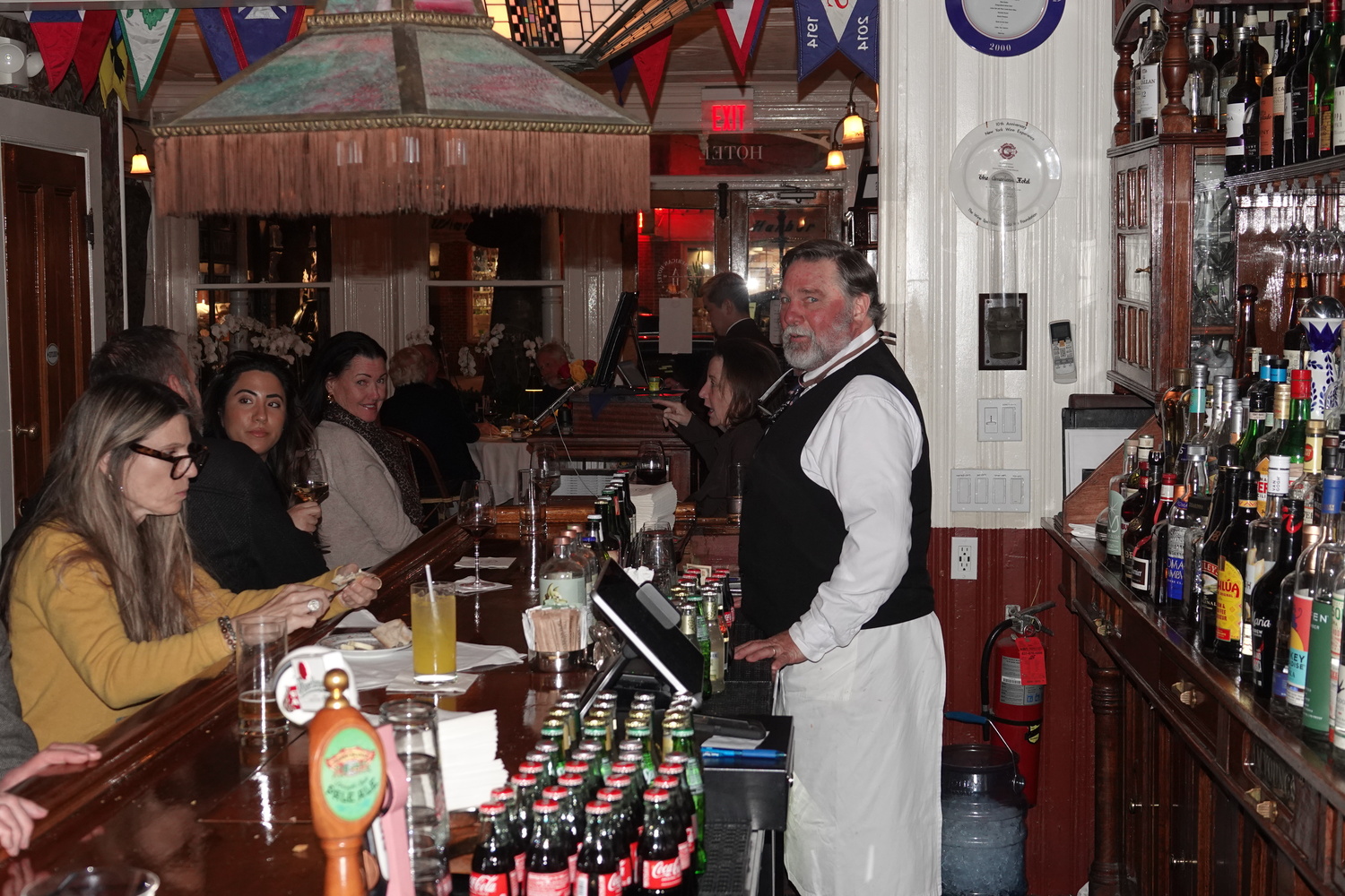 Veteran American Hotel bartender Vin Rom on a Tuesday night in late January, where every stool and seat in the barroom and parlor was full. MICHAEL WRIGHT