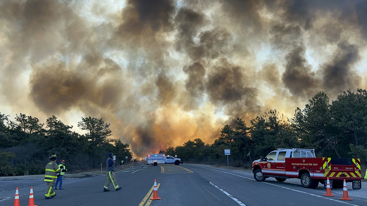 U.S. Air Force firefighters assigned to the 106th Rescue Wing actively fight the Pine Barren Fire off Sunrise Highway on March 8, 2025. Base fire trucks, local departments, and an HH-60W Jolly Green II are on scene. 
New York Air National Guard Photo/Staff Sgt. Sarah McKernan