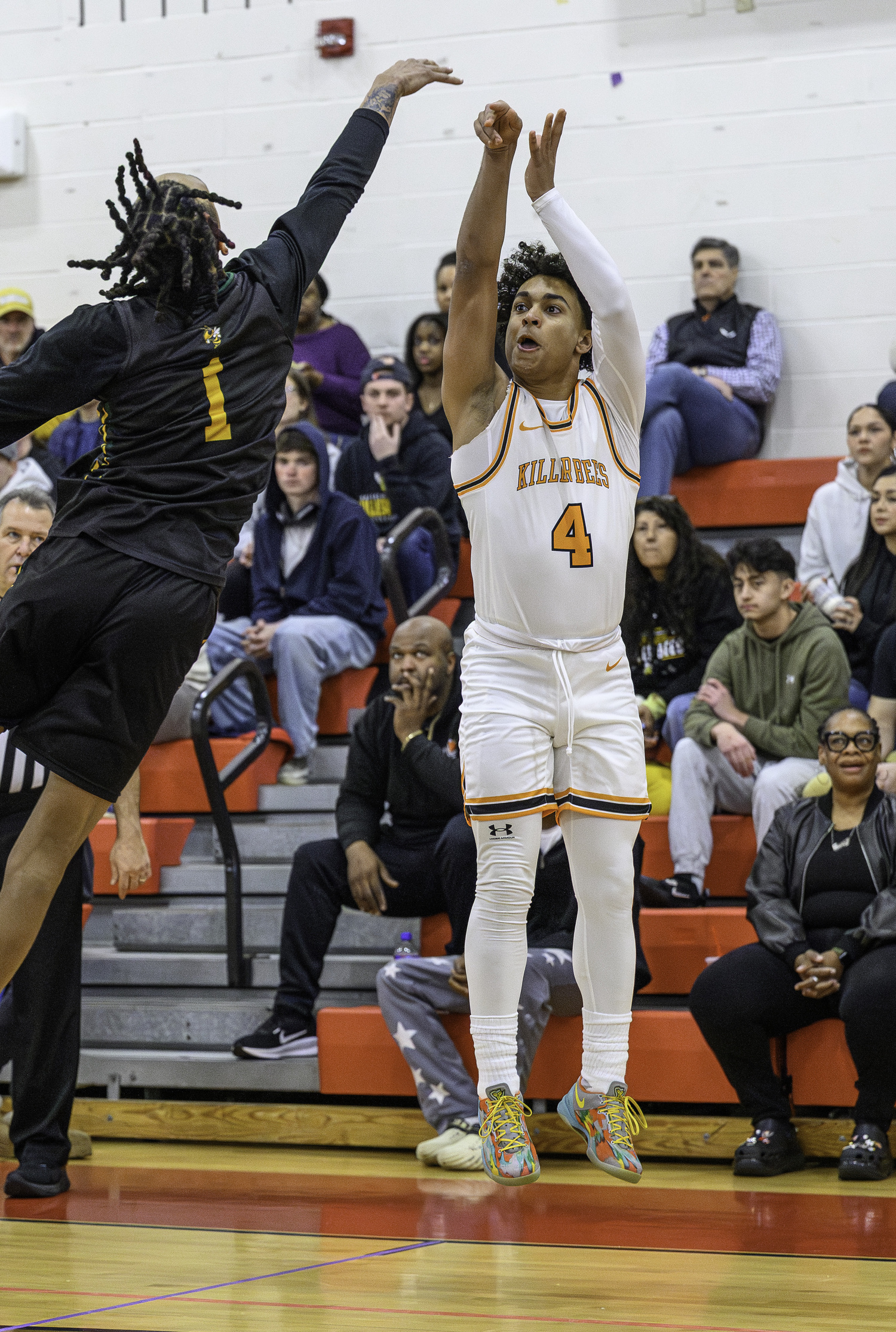 Bridgehampton junior Alex Davis shoots a three over Eldred's Trai Kauffman.  MARIANNE BARNETT